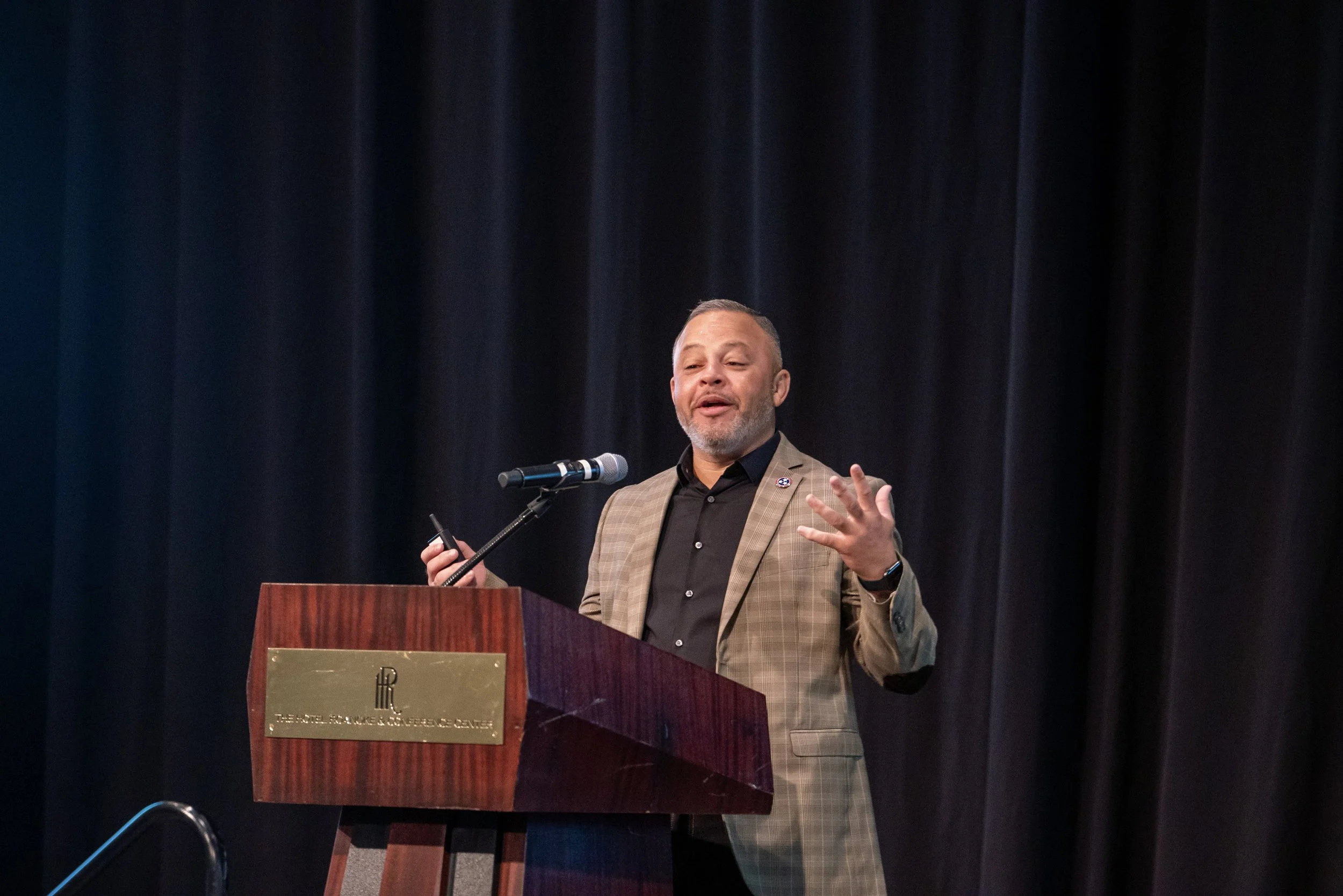 Monty Burks presenting at a podium