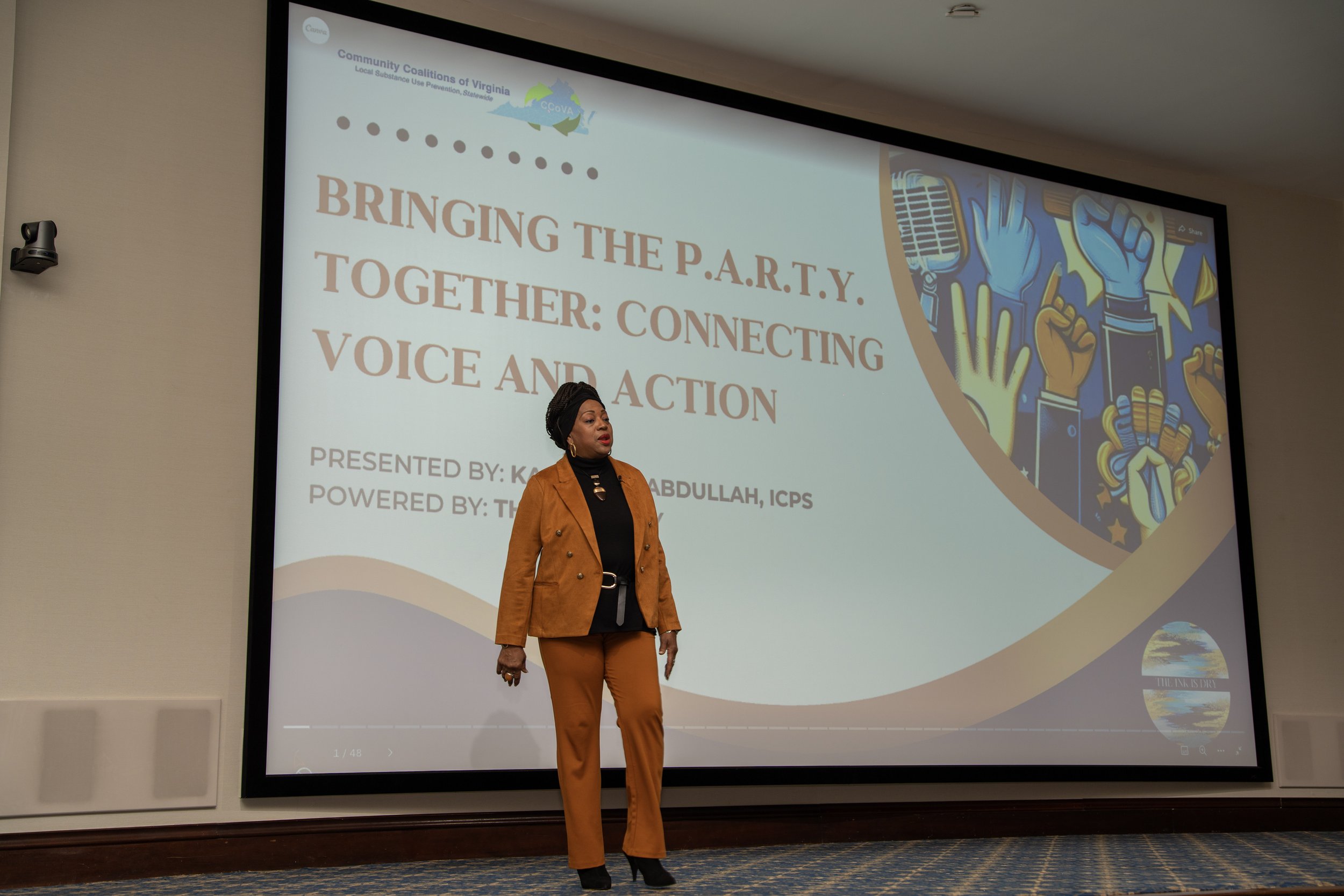 Kareemah Abdullah giving a presentation on stage