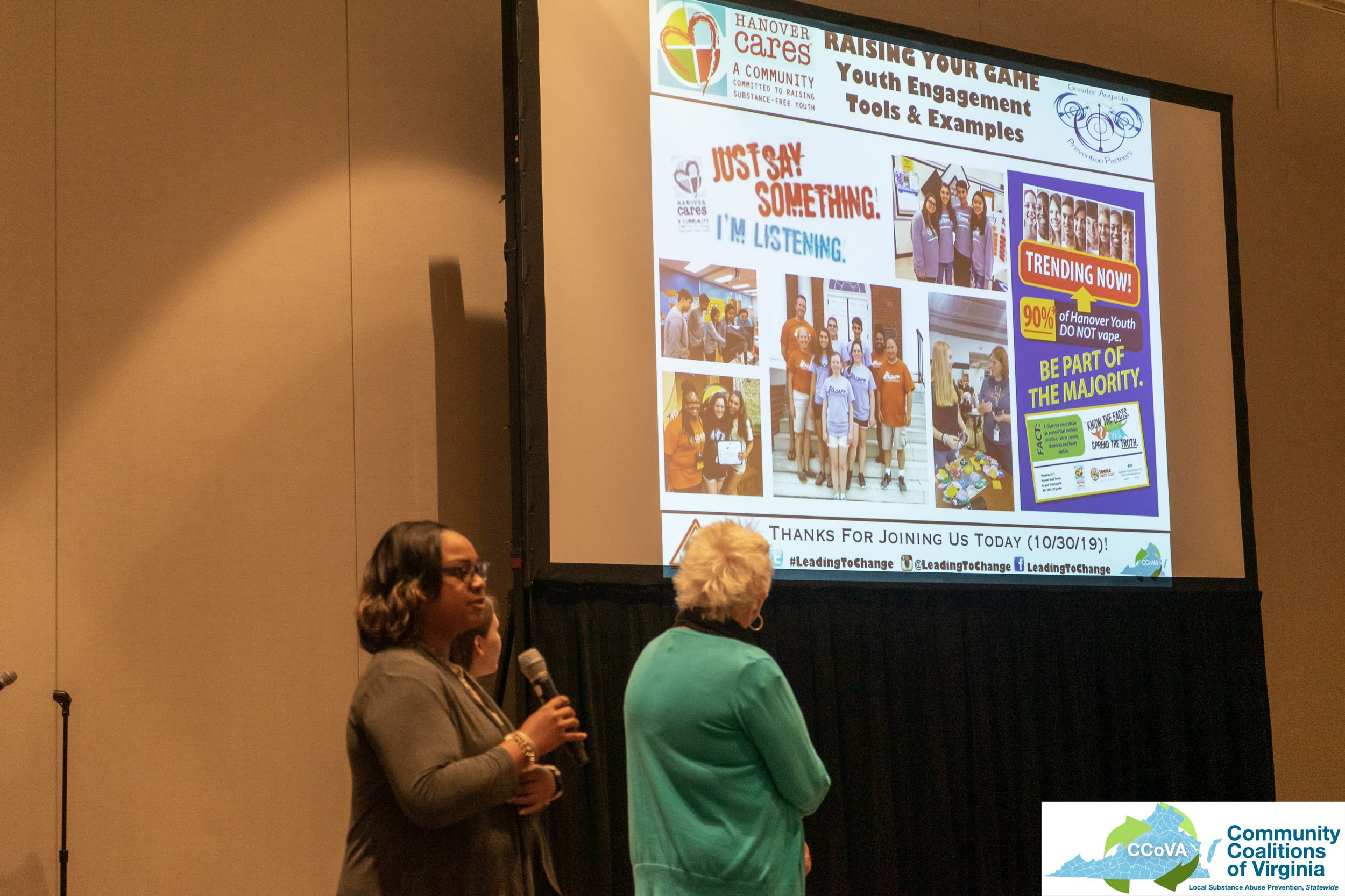 Presenters from Hanover Cares coalition speaking in front of a projector screen