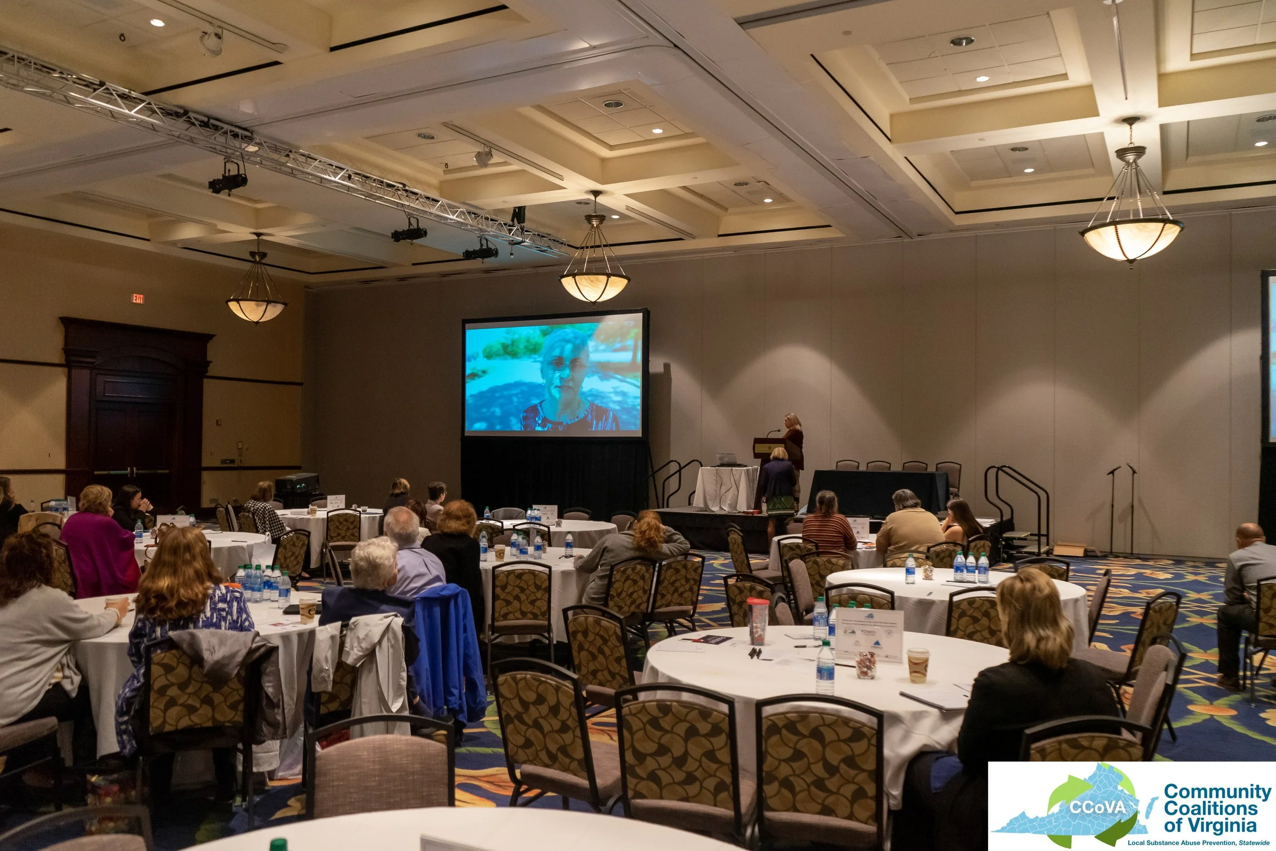 Conference attendees viewing a presentation