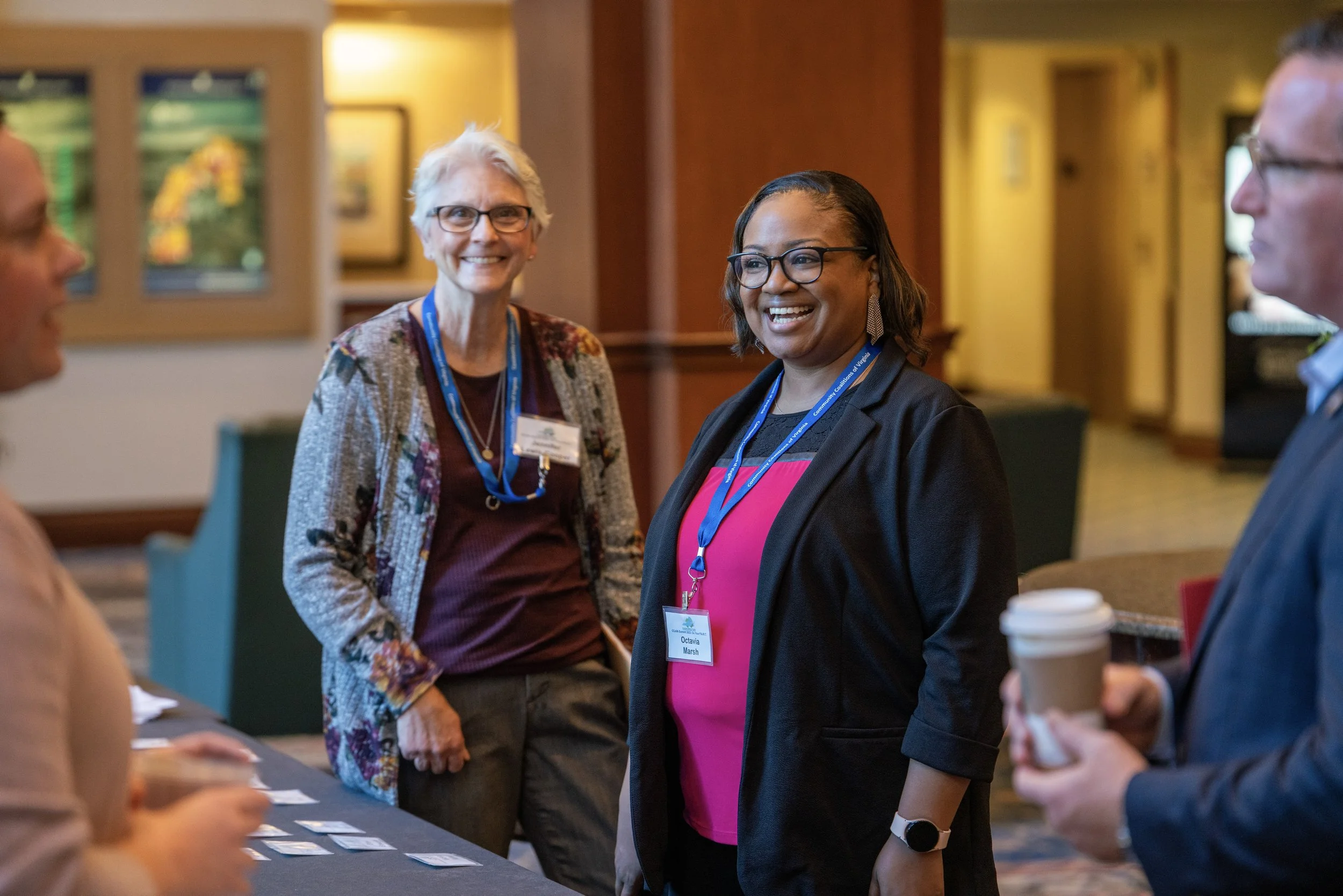 Members of the conference planning team smiling during a networking break