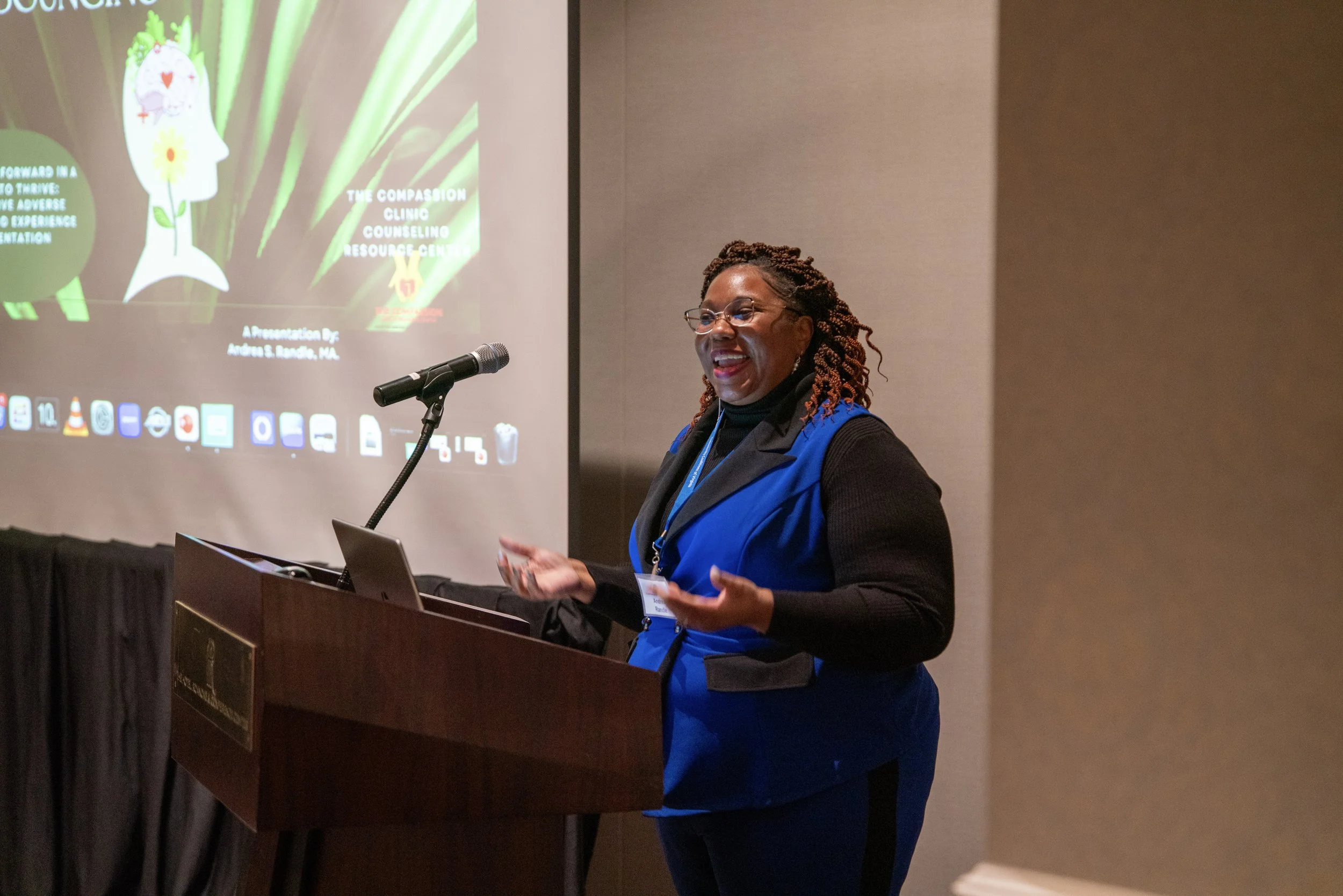 Female presenter speaking at a lectern