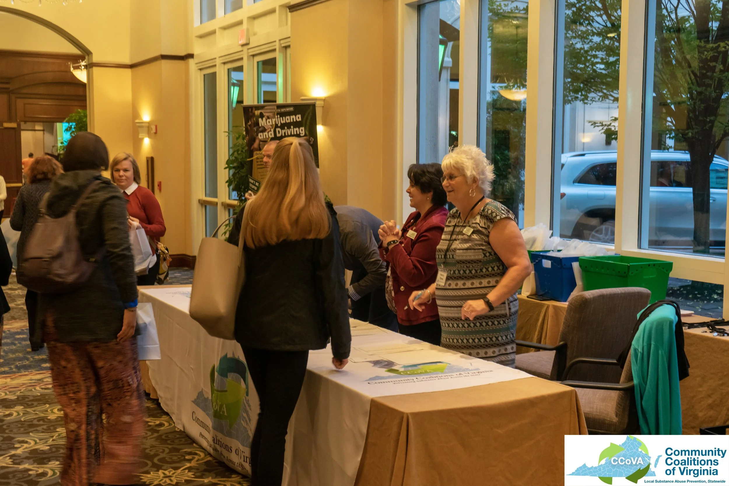 Conference attendees and exhibitors engaged in conversation