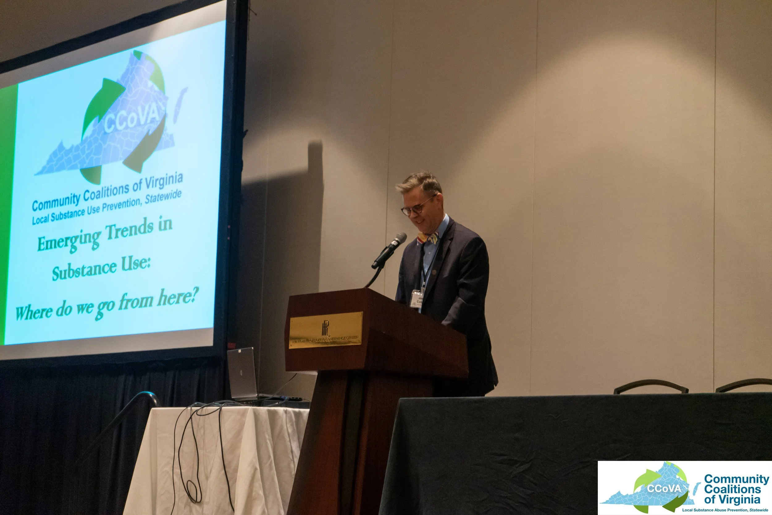 Male presenter at lectern, giving introductory remarks for the conference