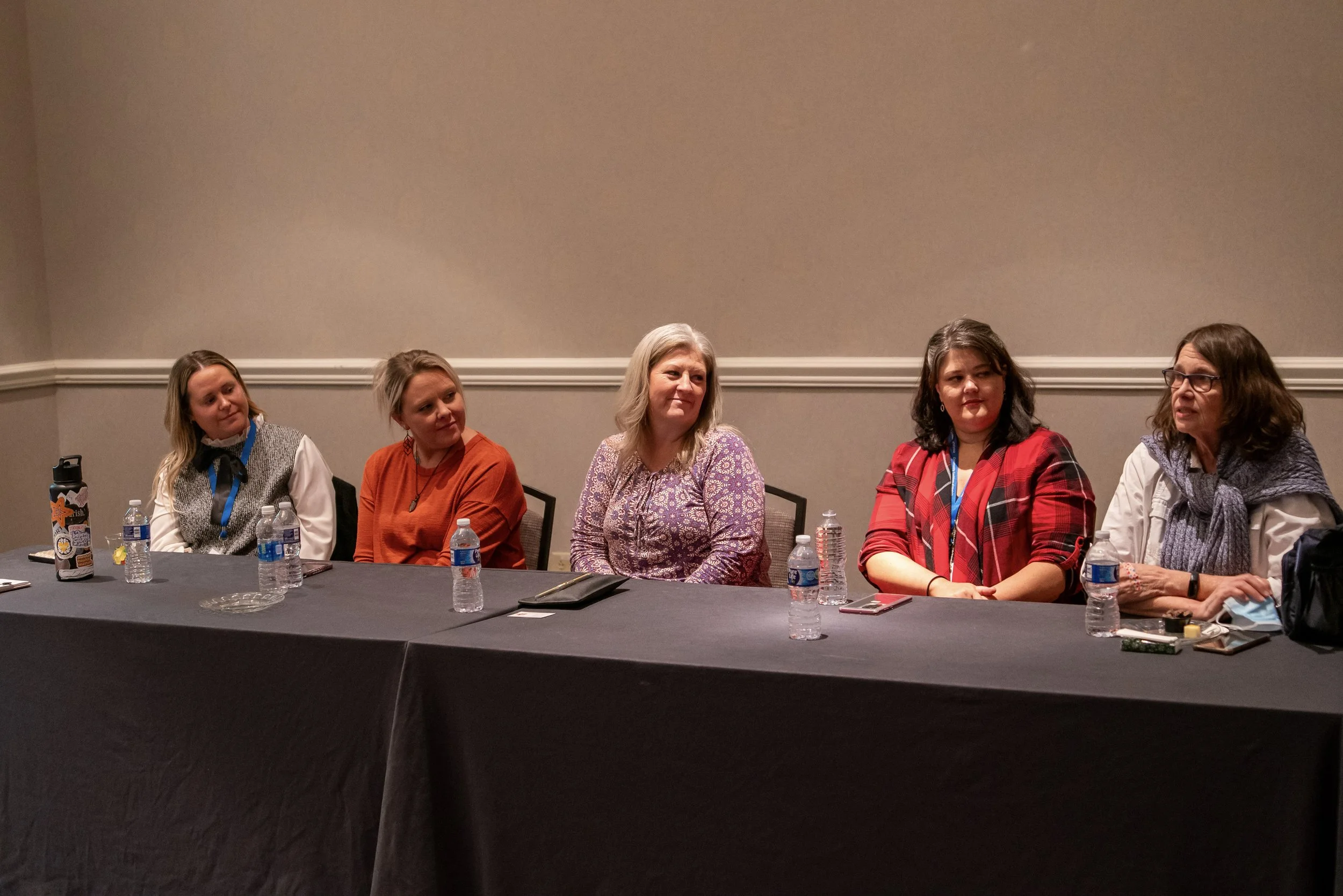 Panel of five women speaking at conference