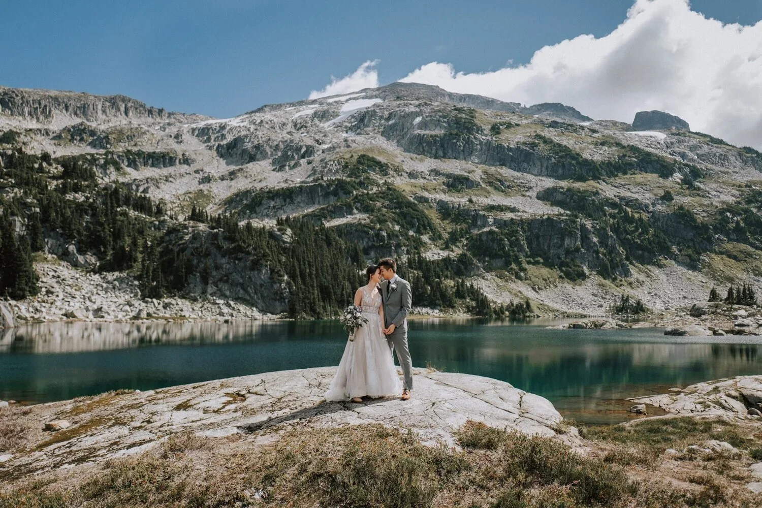 Couple standing by waters of Beverly Lake.