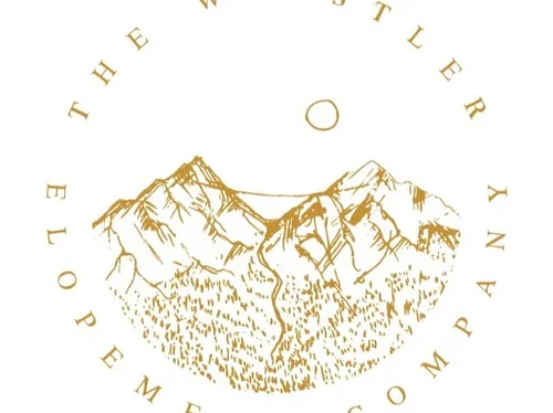 Illustration of mountains with the sun above and surrounded by the text 'The Wilderness in Elopement Company'.