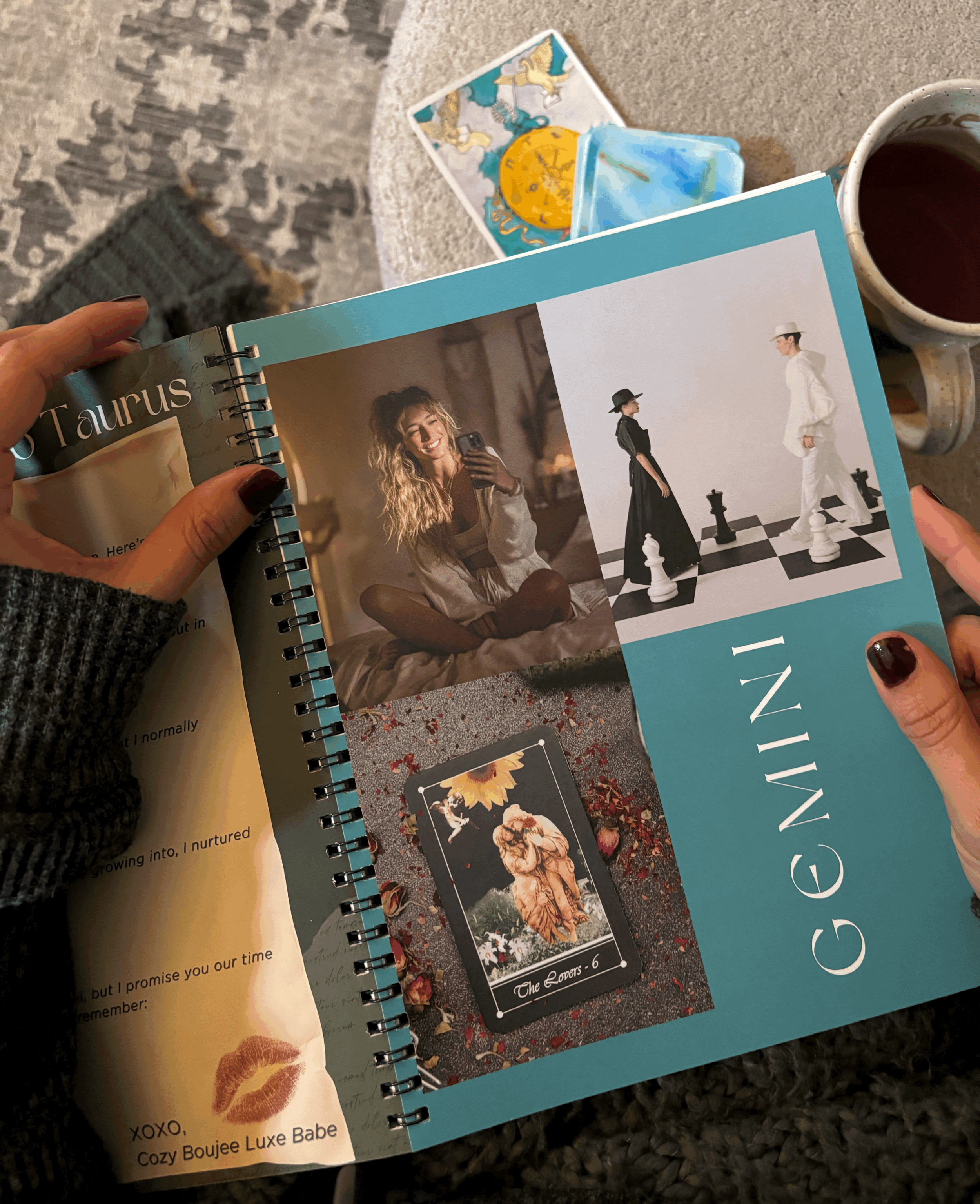 A woman holding the Hidden Threads planner open to the Gemini season spread, featuring editorial fashion photography and The Lovers tarot card.
