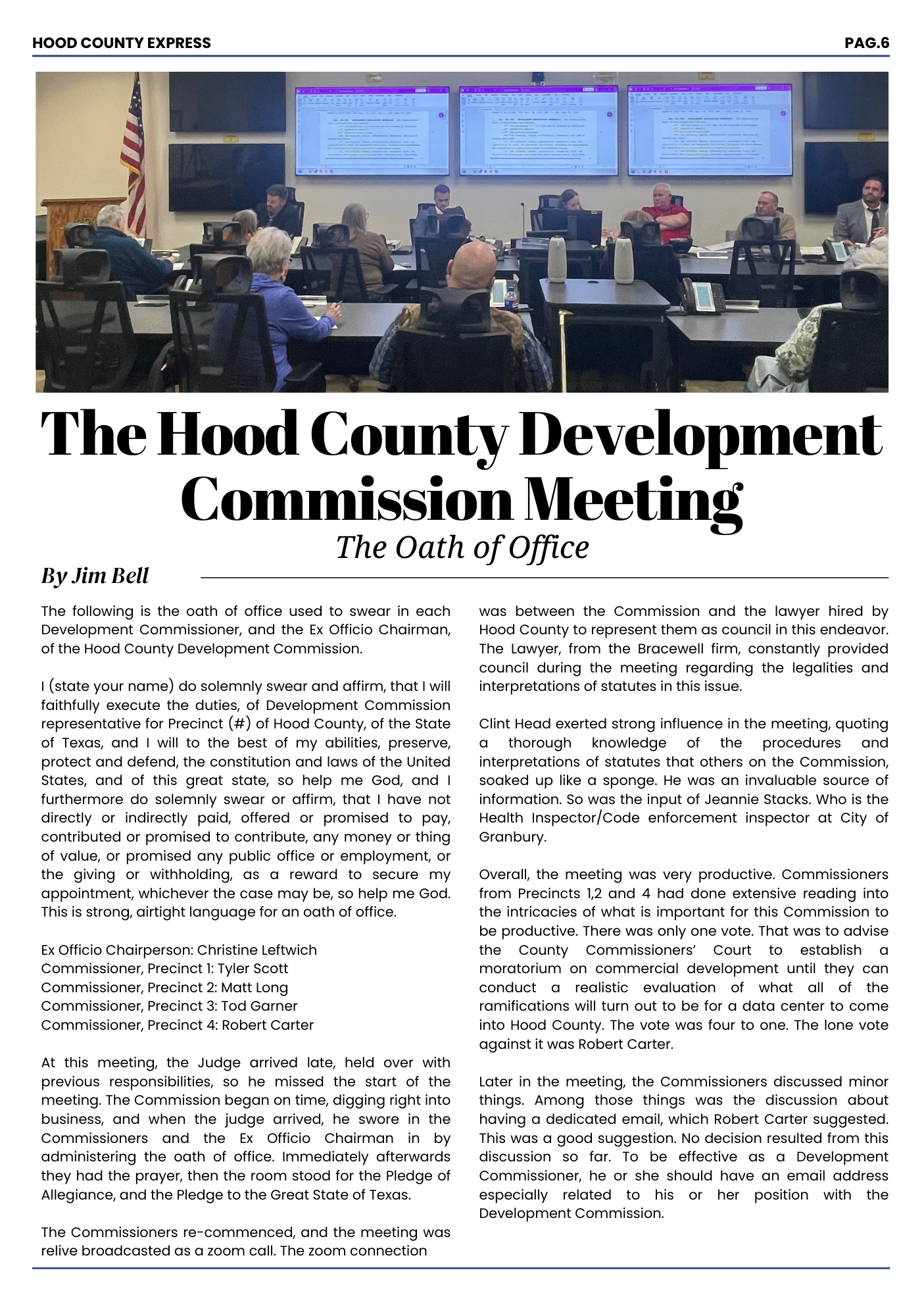 A screenshot of a newspaper page titled "The Hood County Development Commission Meeting" with a large room of people seated at tables, facing large screens displaying documents. An American flag is visible in the corner.