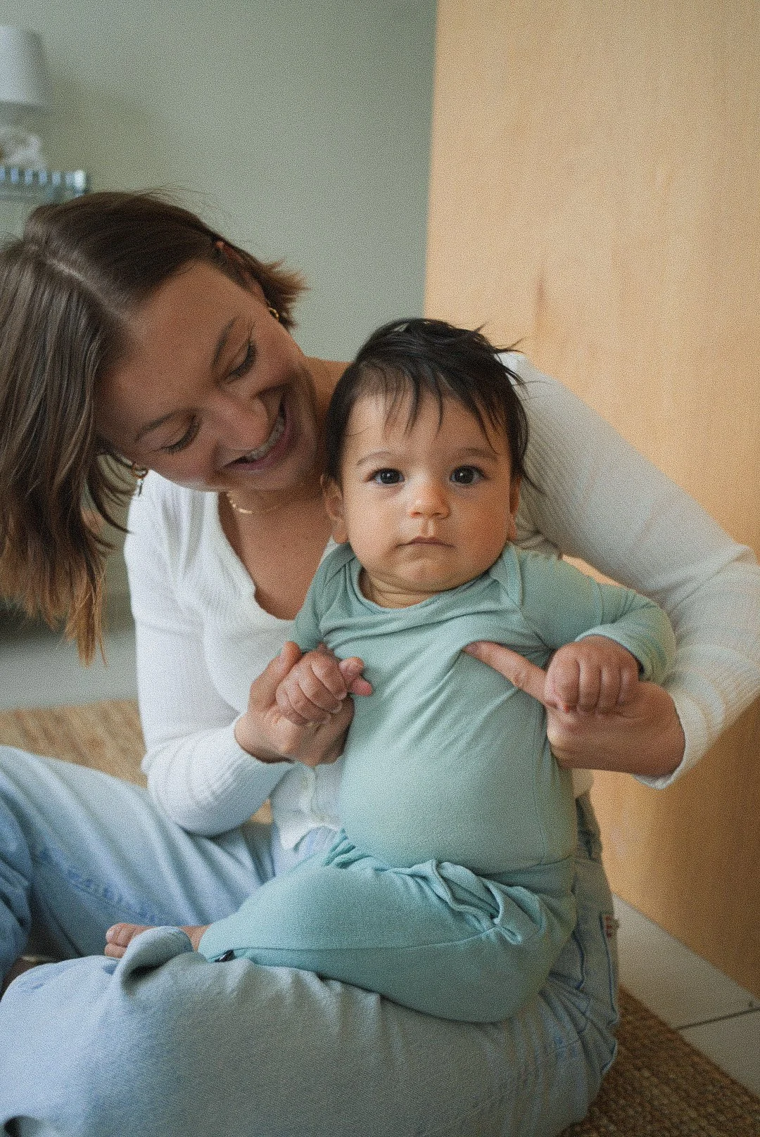 Dr. Madison Smith smiles while posing with one of her youngest clients, demonstrating that it is safe for babies to receive chiropractic care.