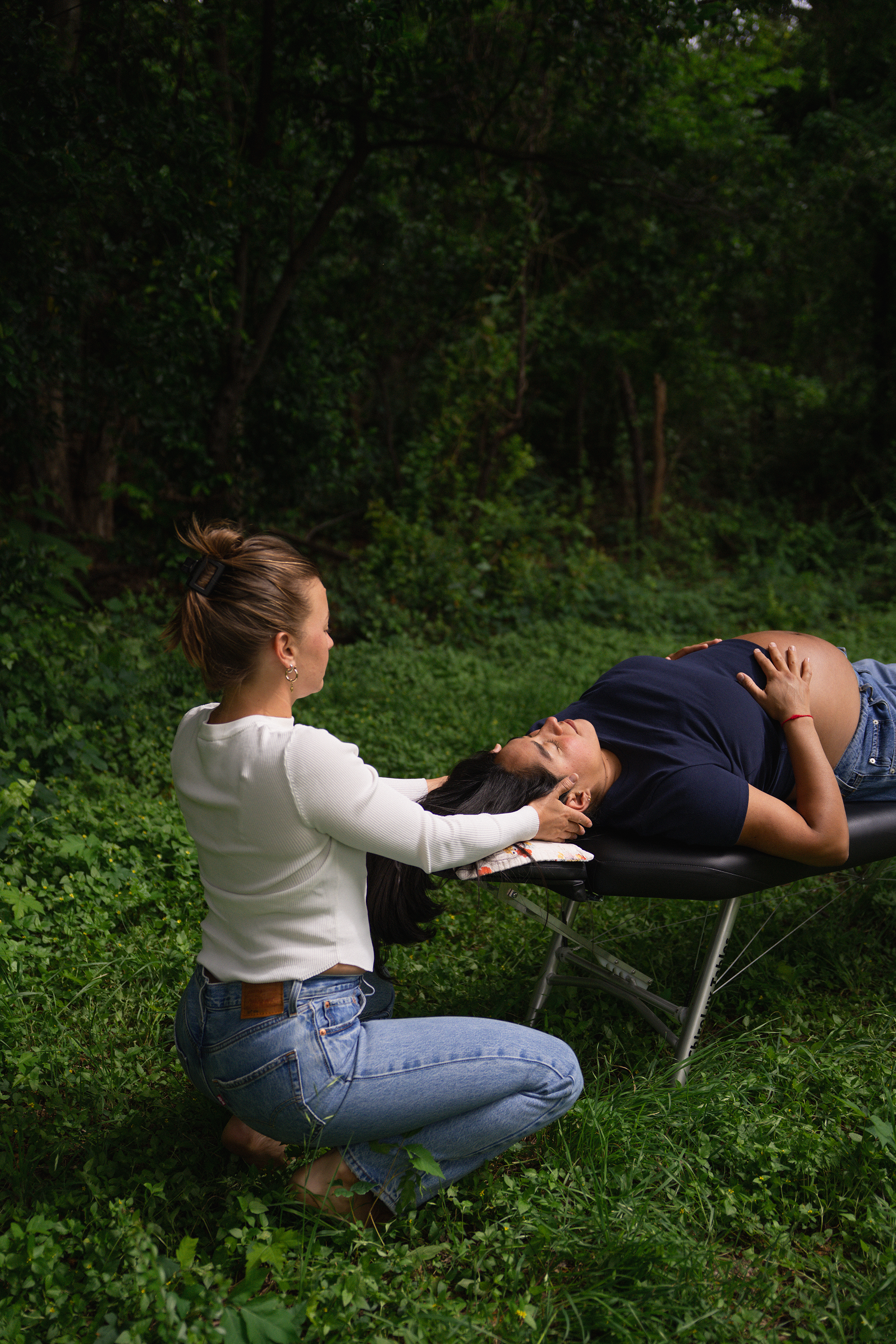 Dr. Madison Smith gently adjusts a client through vitalistic chiropractic care.