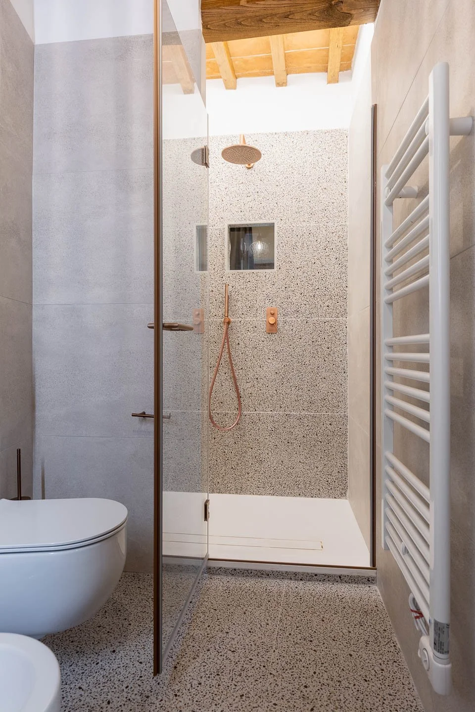 Modern bathroom with walk-in shower in a high-end holiday apartment in San Gimignano old town, Tuscany