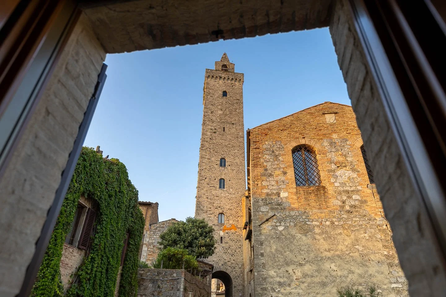 View of a medieval tower from a holiday apartment in the historic center of San Gimignano