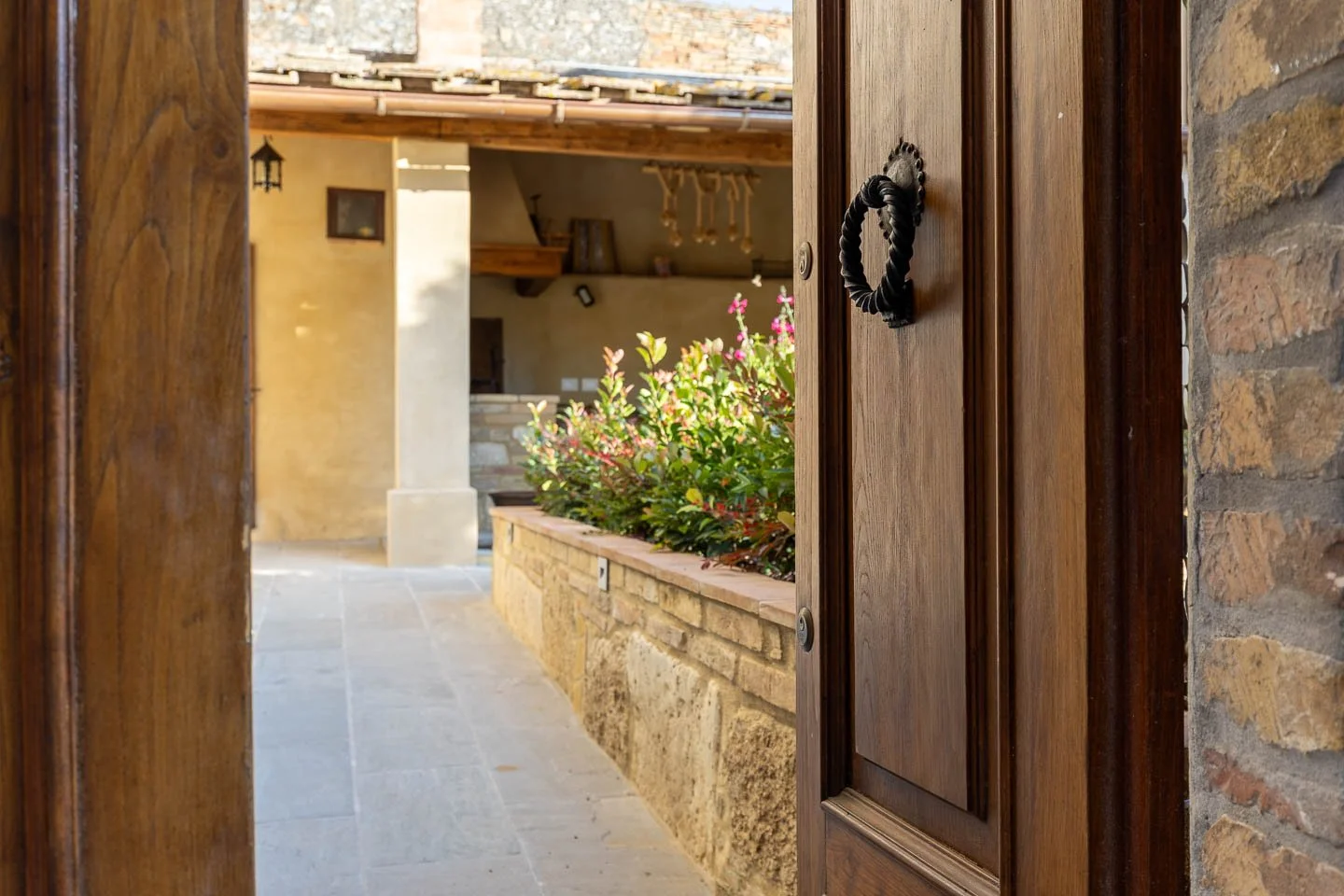 Entrance to the private courtyard patio in a high-end holiday apartment in San Gimignano old town, Tuscany