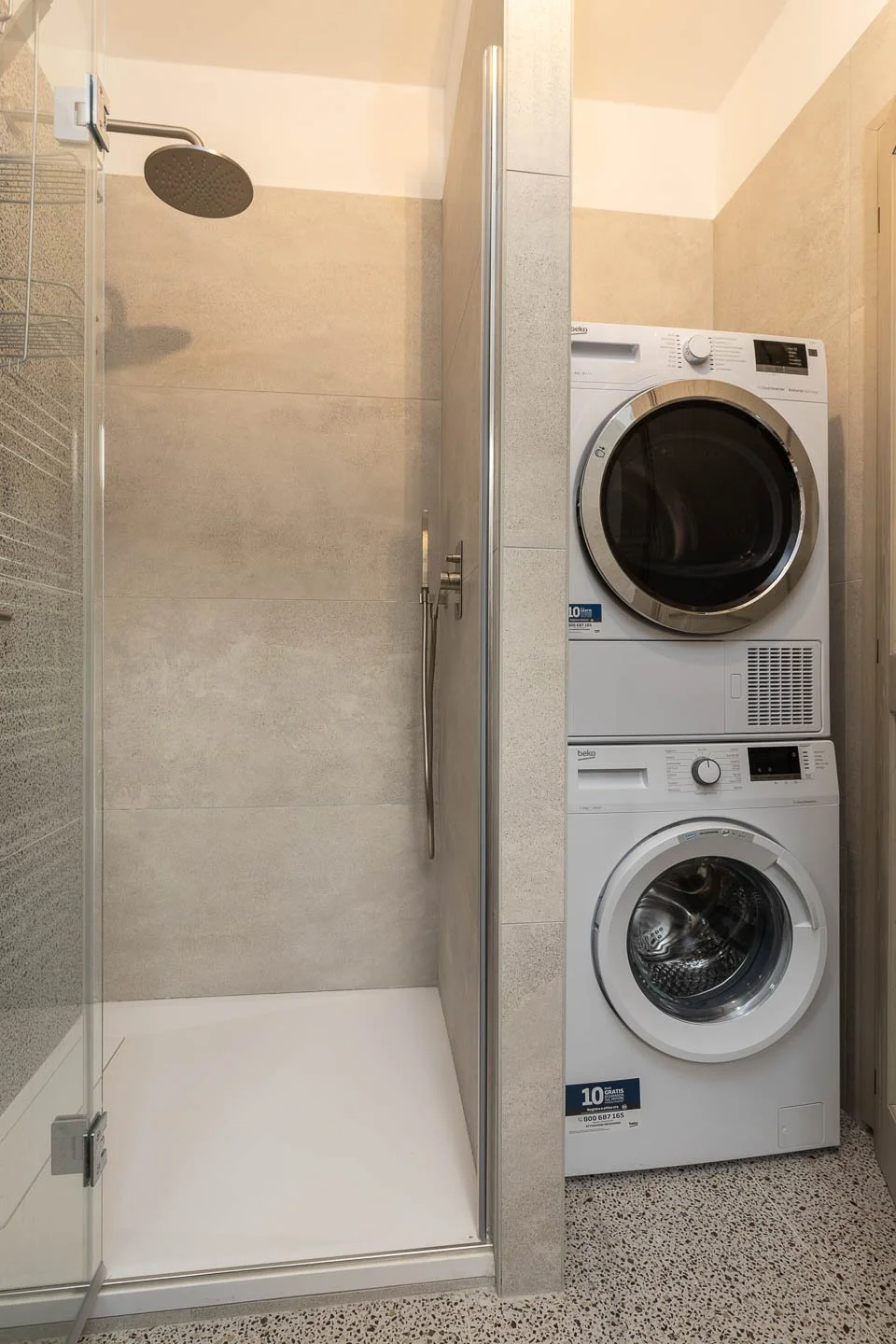 Private laundry room with washing machine and dryer in a premium holiday apartment in the historic center of San Gimignano