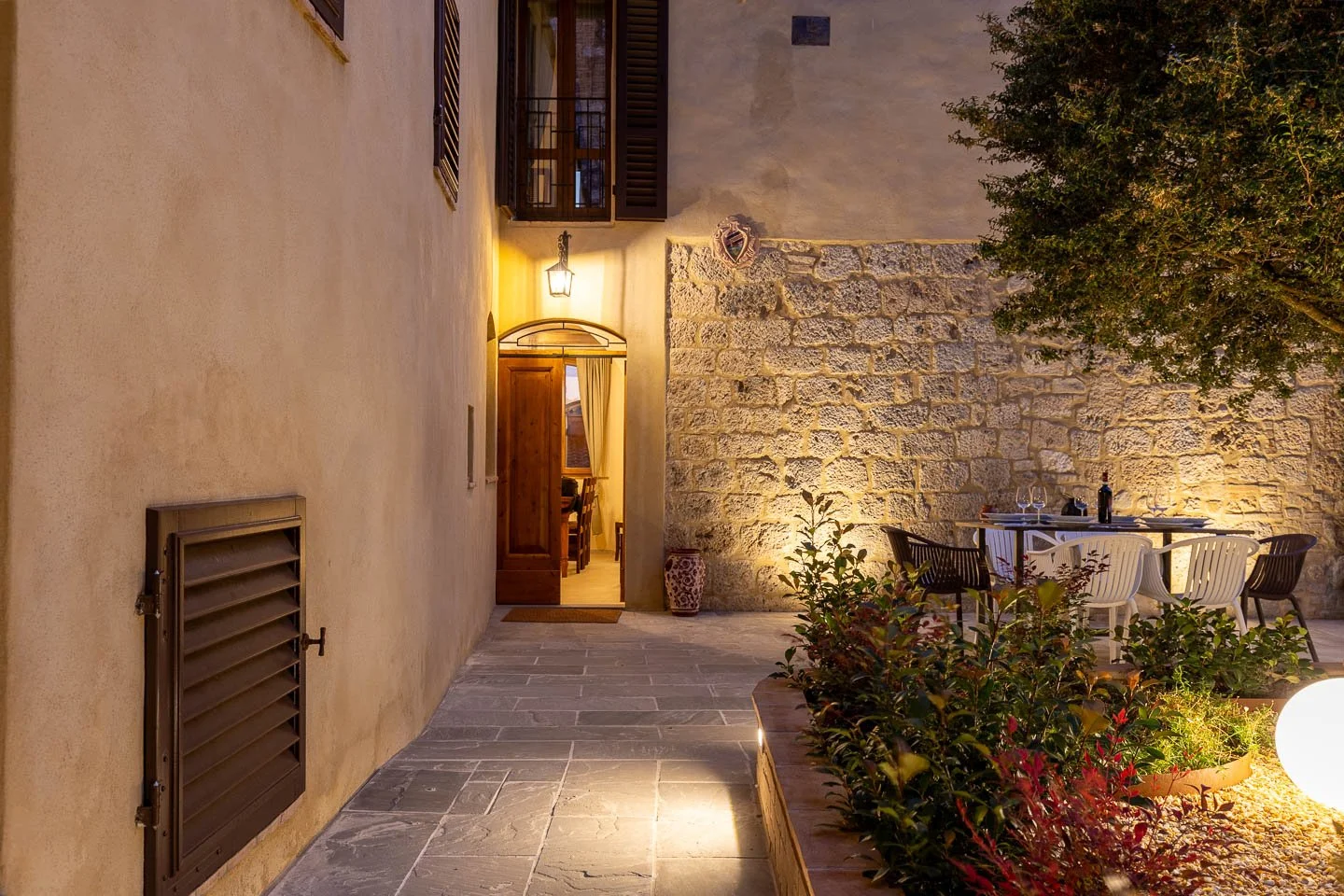 Private courtyard patio at night in a high-end holiday apartment in the historic center of San Gimignano