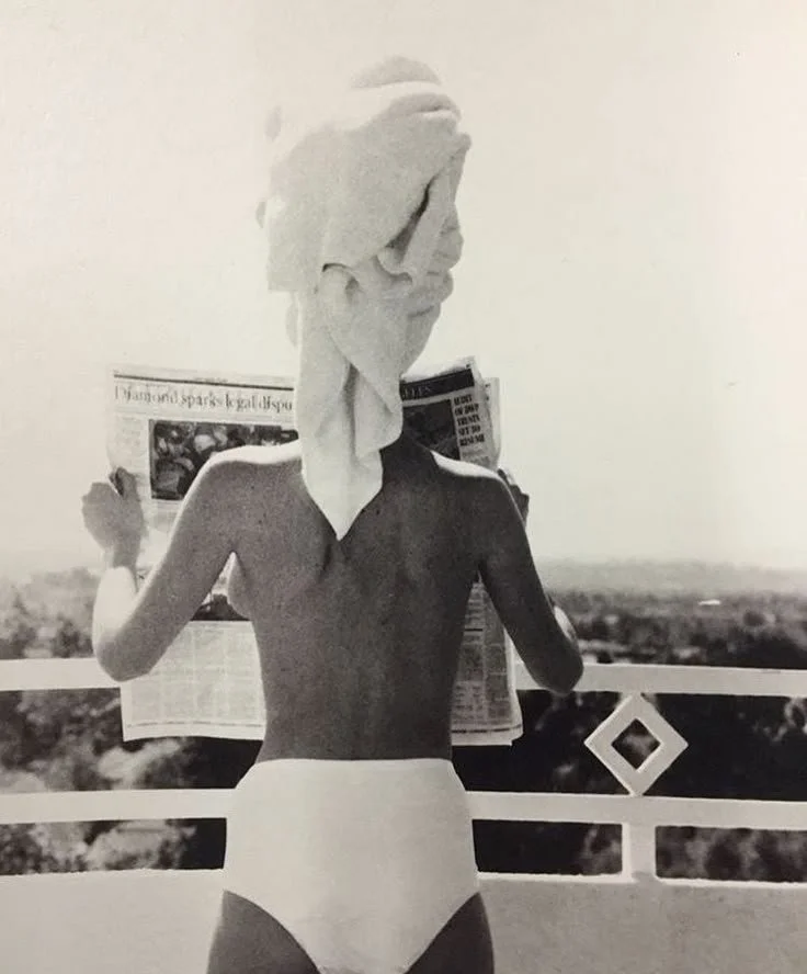 Photo of a woman with tanned skin, reading the news