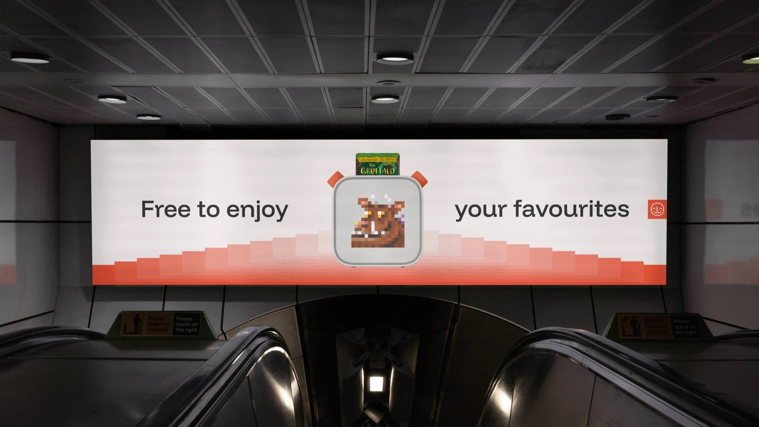 Digital advertisement on an underground escalator screen showing an app with a pixelated tiger icon, stating 'Free to enjoy your favorites'.