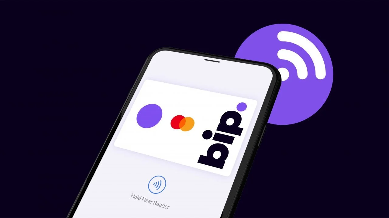Smartphone with a contactless payment screen displaying the 'bid' logo and Mastercard logo, near a purple contactless payment symbol on a dark background.