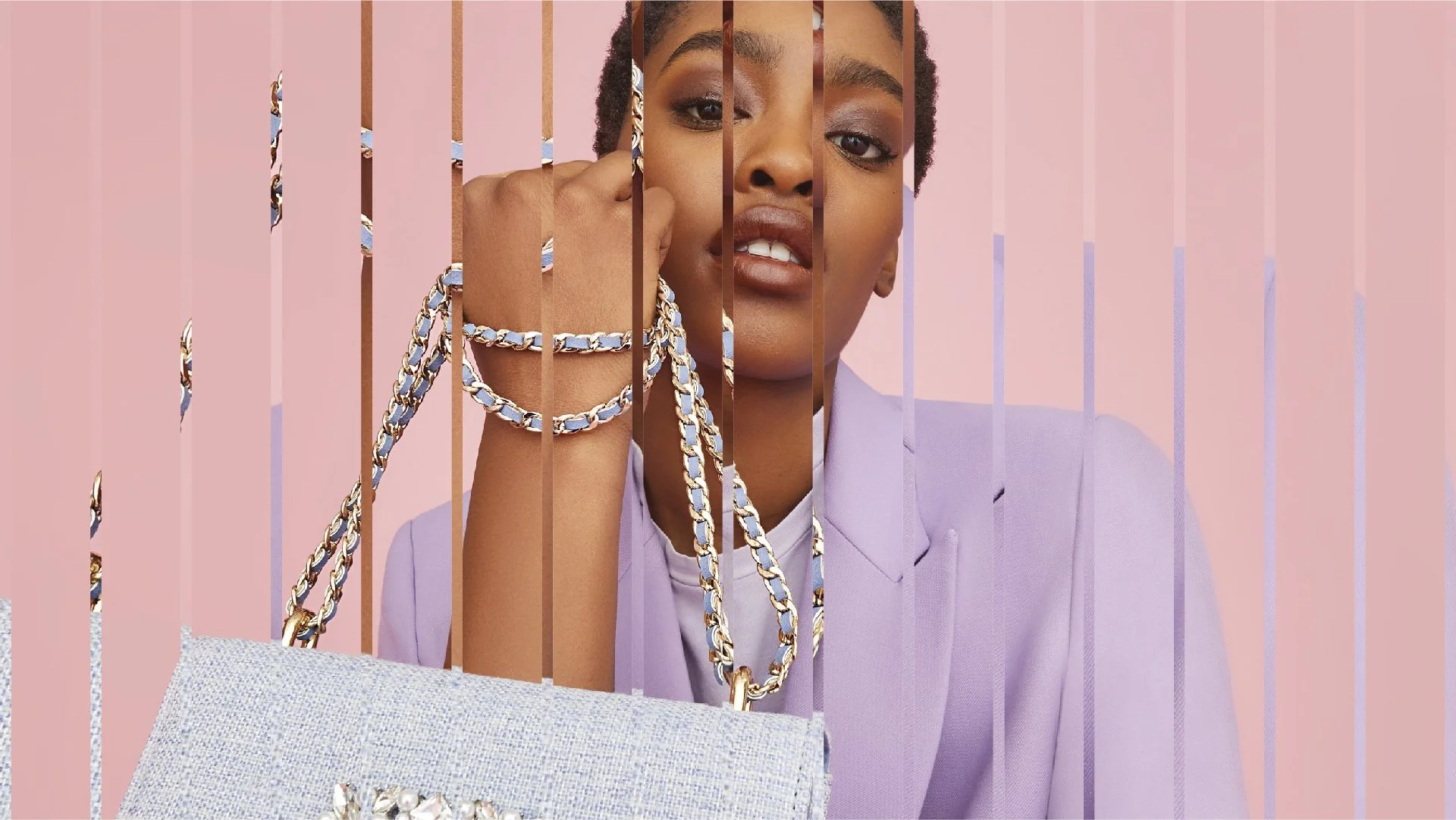 A woman in a pastel purple blazer holding a silver purse with a decorative clasp, standing behind vertically aligned pink bars that are cut out of the image, creating a fragmented view of her face, hand, and jewelry, with a soft pink background.