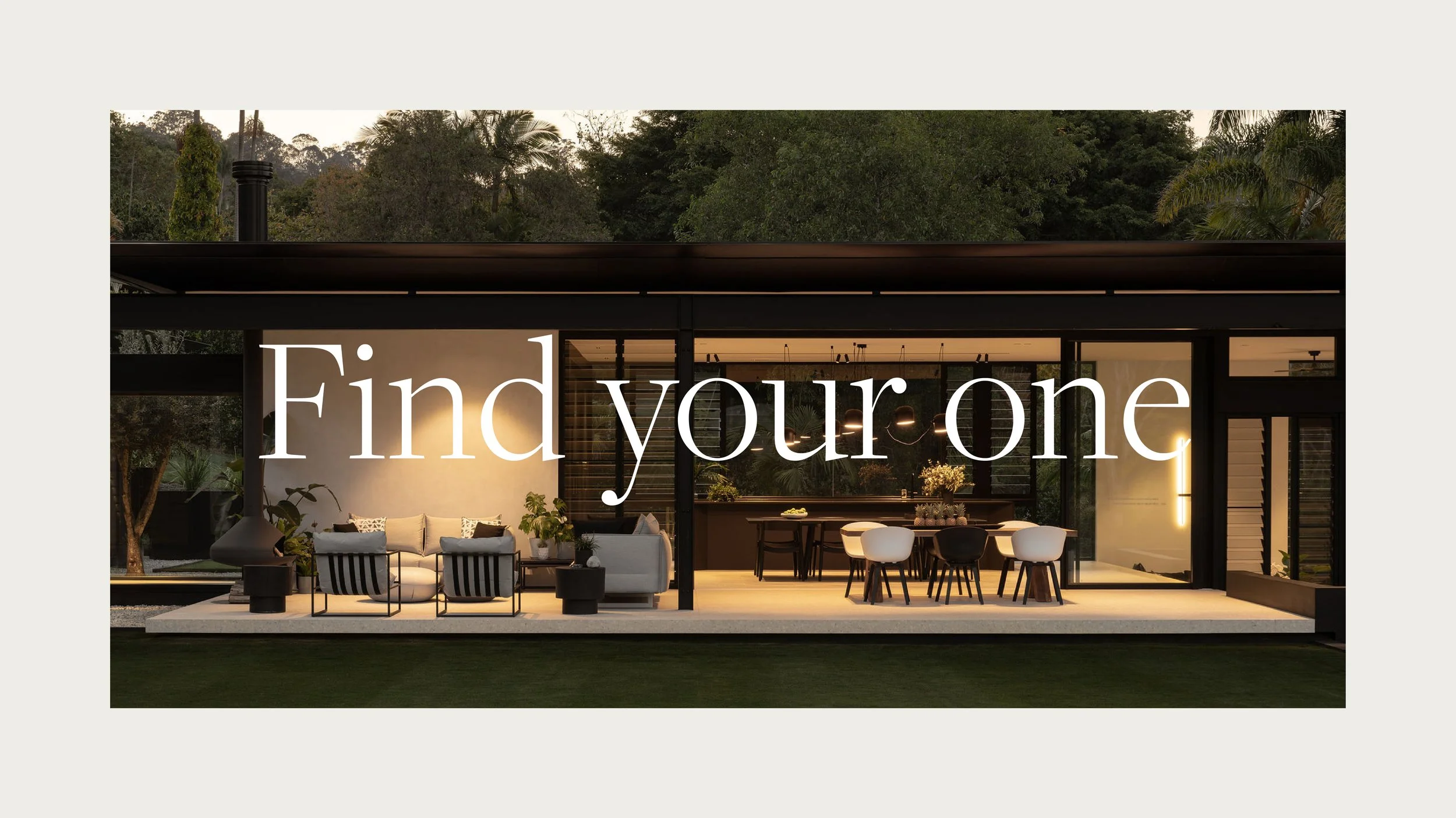 Modern house with large glass windows and outdoor patio with seating and dining area, surrounded by trees and greenery, during dusk. "Find your one" written over the top in the Sotheby's International Realty brand.