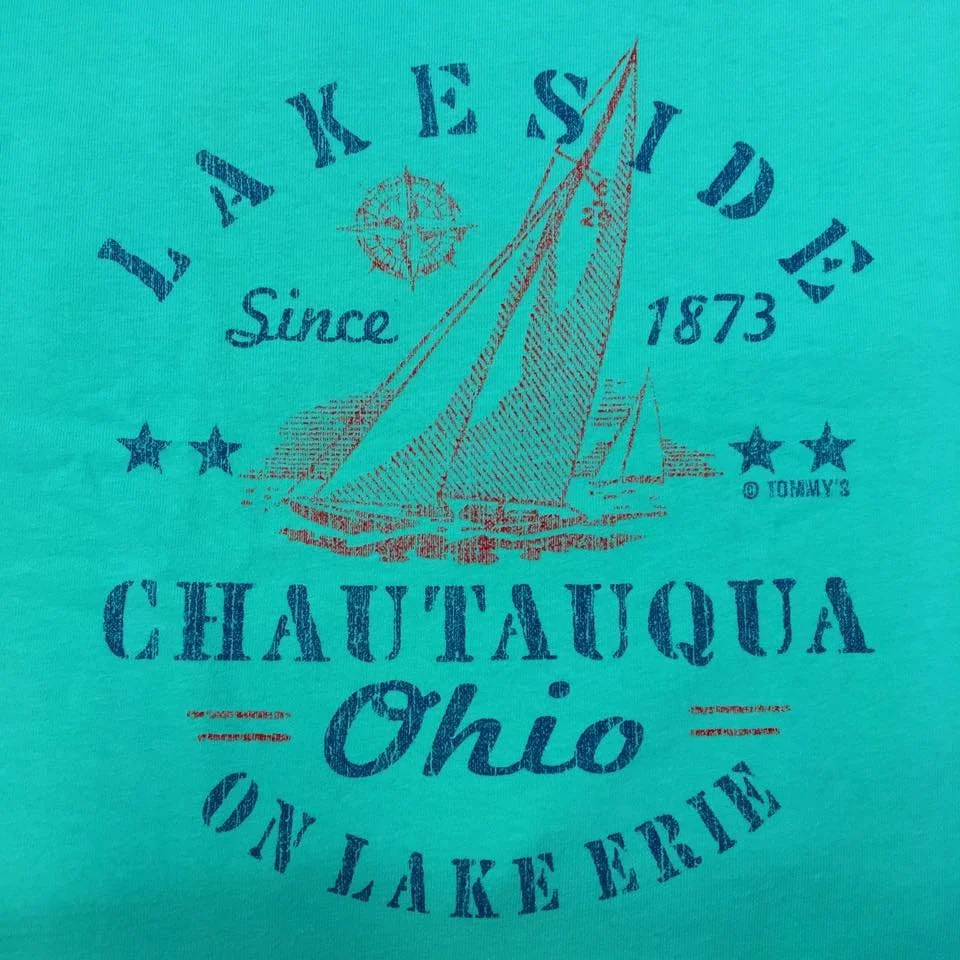 Graphic design featuring a sailboat, text reading "Lake Shore Drive Since 1873," "Chautauqua Ohio," and "On Lake Erie," with stars, a compass, and distressed font on a turquoise background.