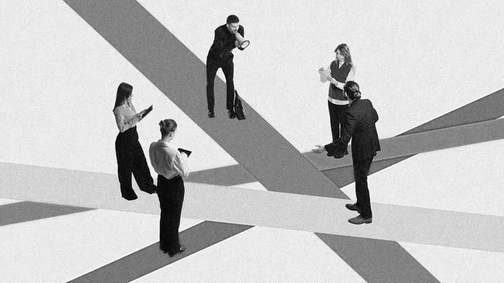 Five adults standing on intersecting lines, all looking at their phones, in a black and white setting.