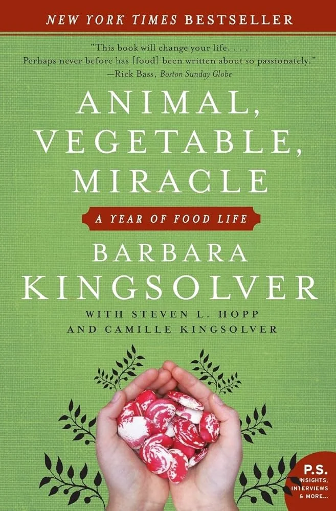 Book cover titled 'Animal, Vegetable, Miracle' by Barbara Kingsolver, with co-authors Steven L. Hopp and Camille Kingsolver. The cover features a hand holding red and white patterned beans, surrounded by illustrated green leaves, against a green background. The top has a red banner indicating it is a 'New York Times Bestseller' and an anecdotal quote about the book at the top.