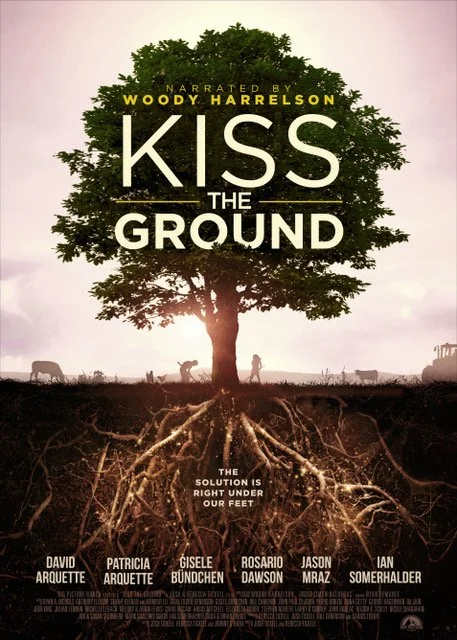 Movie poster for 'Kiss the Ground' featuring a tree with visible roots and a sunset background, with people and animals silhouettes.