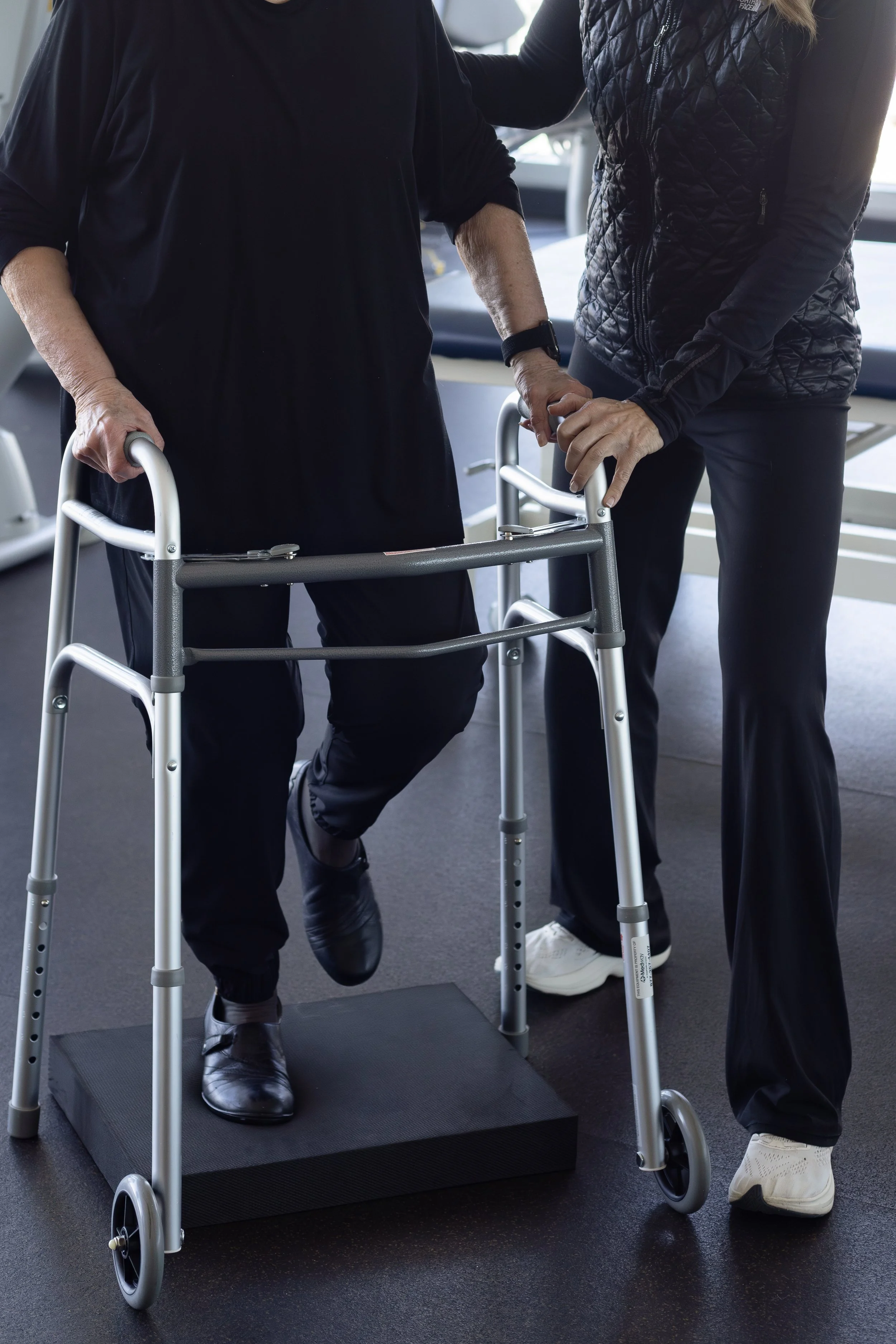 Therapist helping elderly patient with balance and coordination for fall prevention
