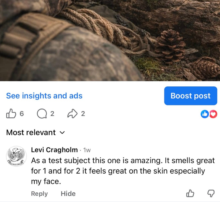 Scenic landscape with a large body of water in the foreground, rolling grassy hills, and mountain range in the background under a cloudy sky.