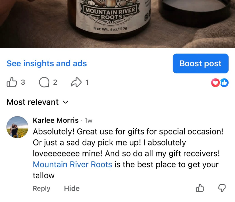 A mountain landscape with snow-capped peaks in the background, rolling grassy hills in the middle, and a modern building in the foreground.