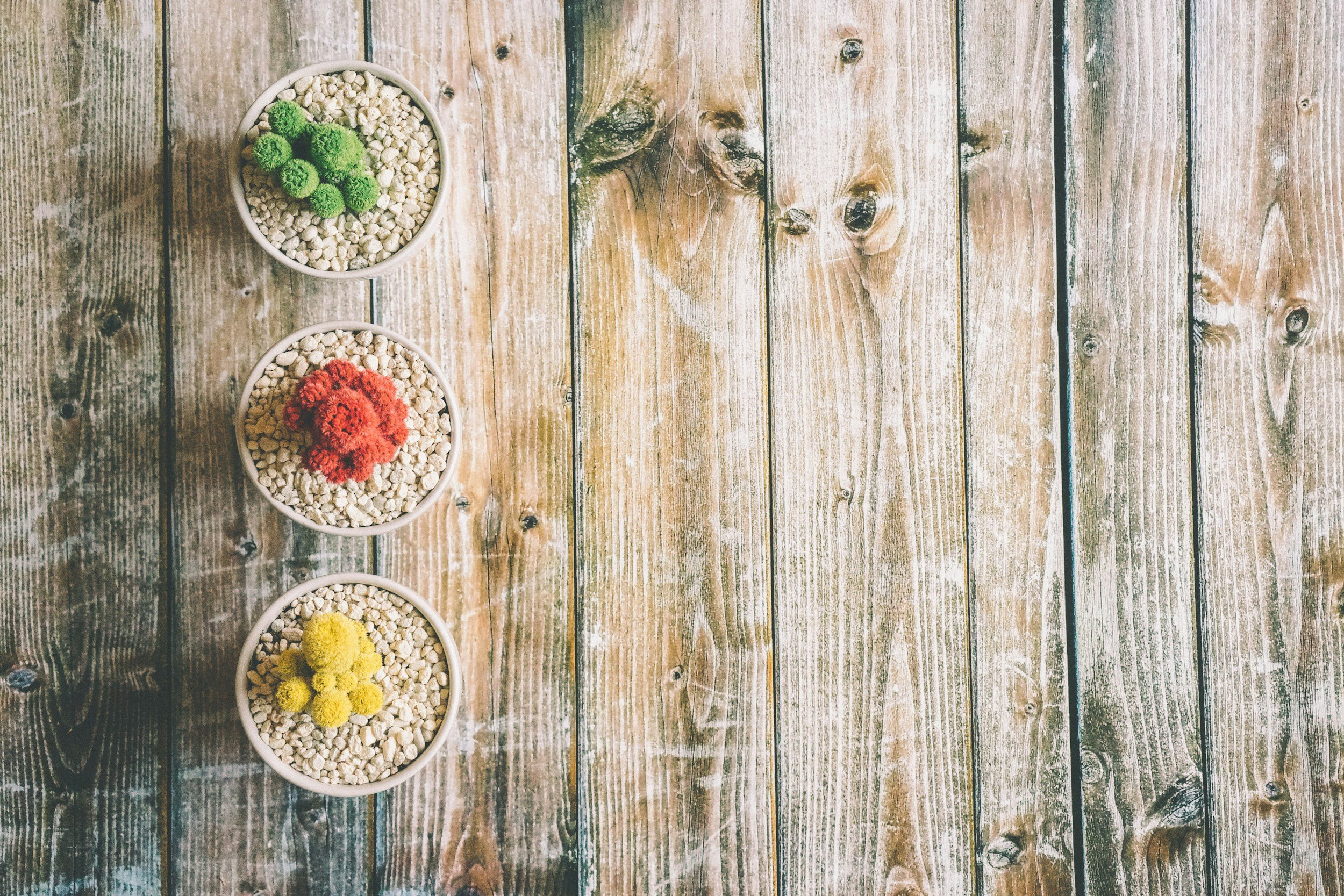 Three round bowls on a wooden surface symbolizing three men building their relationship.