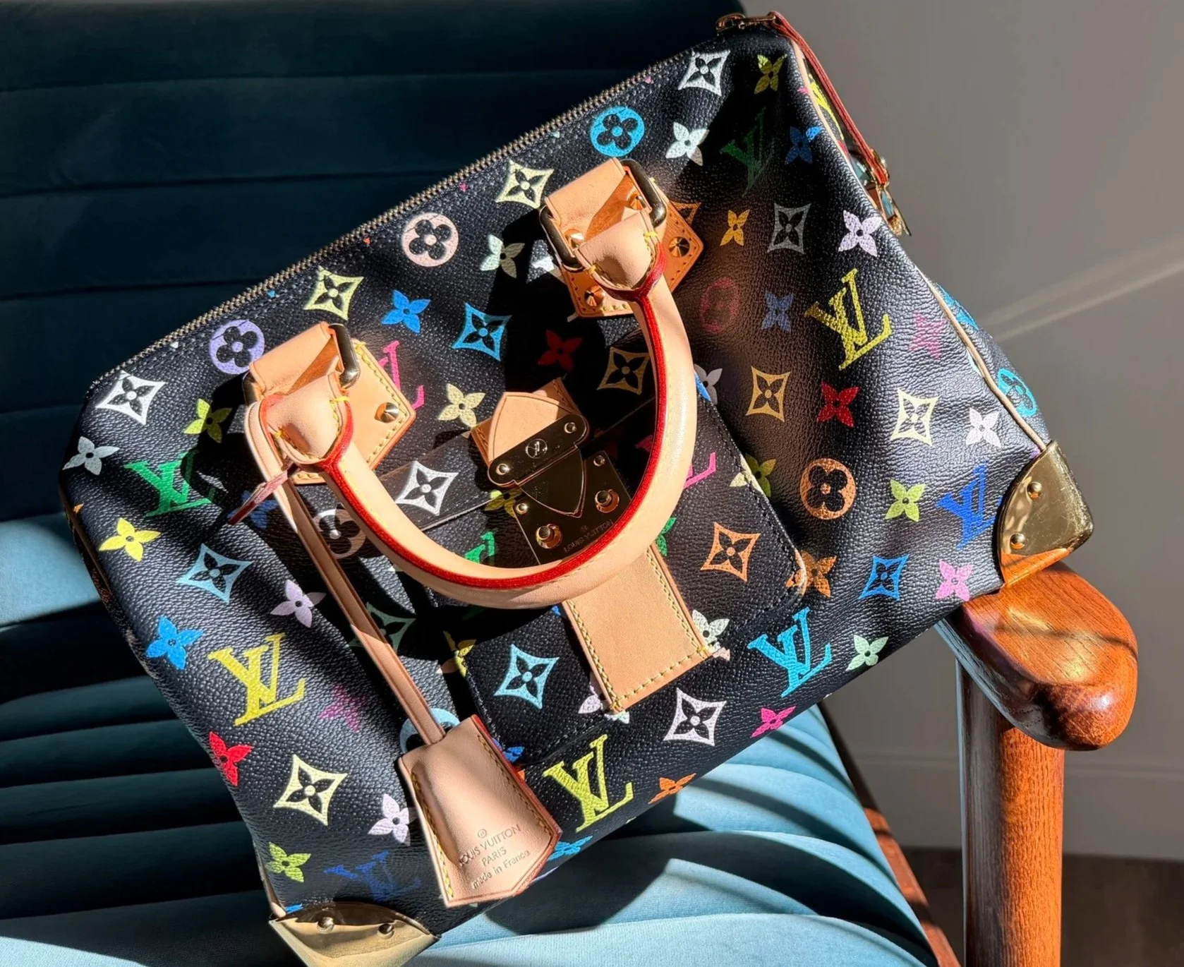 A Louis Vuitton Murakami monogram canvas bag with multicolored logo.
