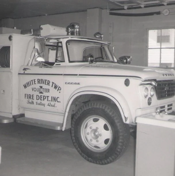 Vintage White River Township volunteer fire truck in a fire station garage.