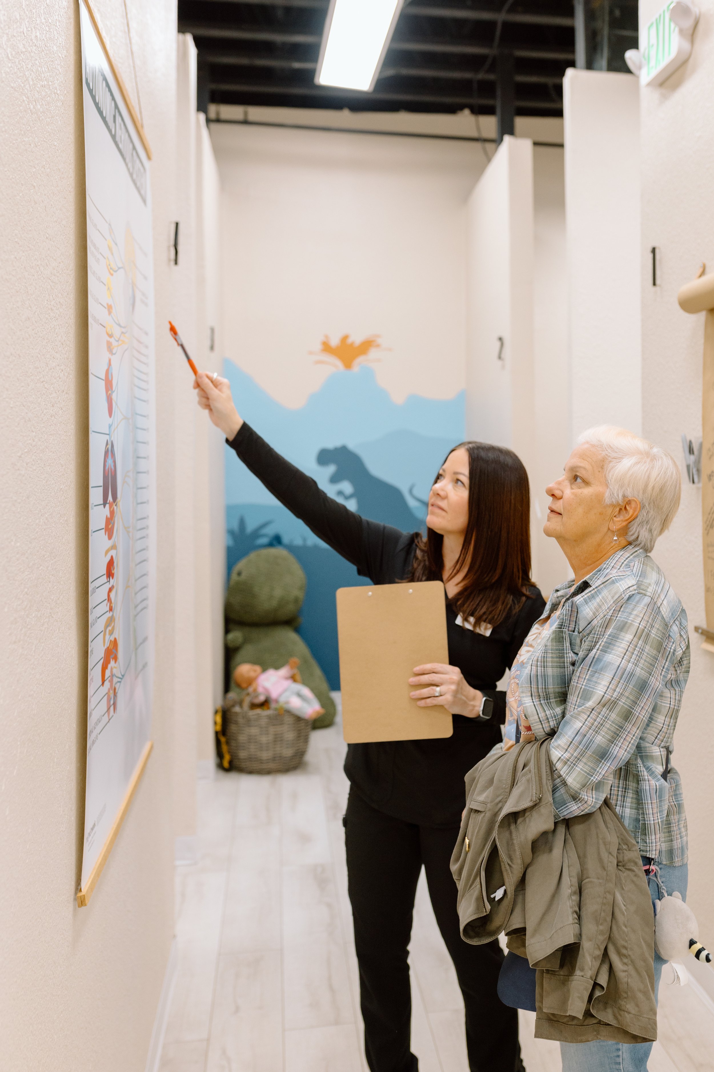Chiropractic team member giving an office tour to new patients in neurologically-based chiropractic office in Gilbert, Arizona