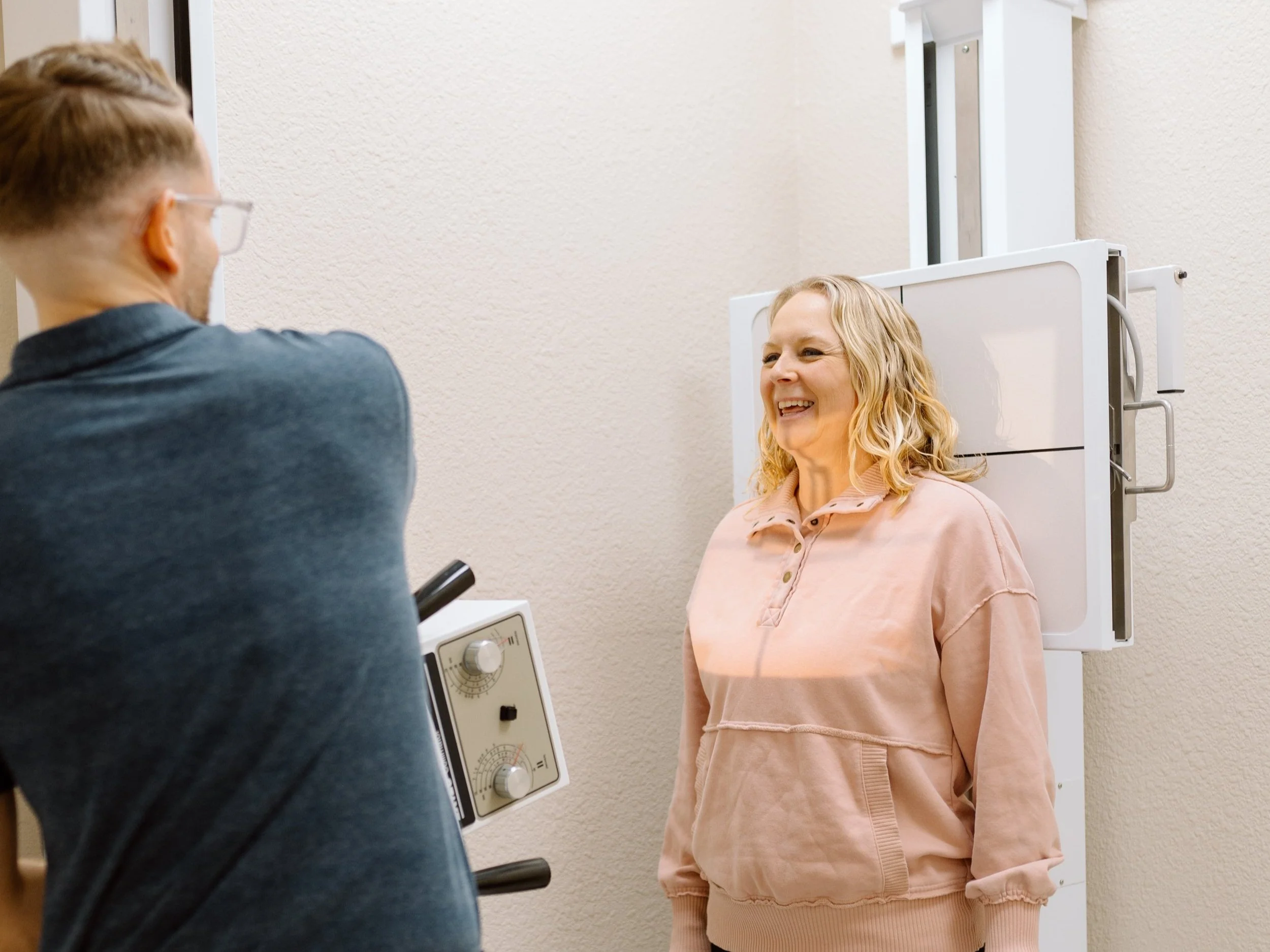 Doctor takes spinal x-rays of the neck on new patient in neurologically-based chiropractic office in Gilbert, Arizona.