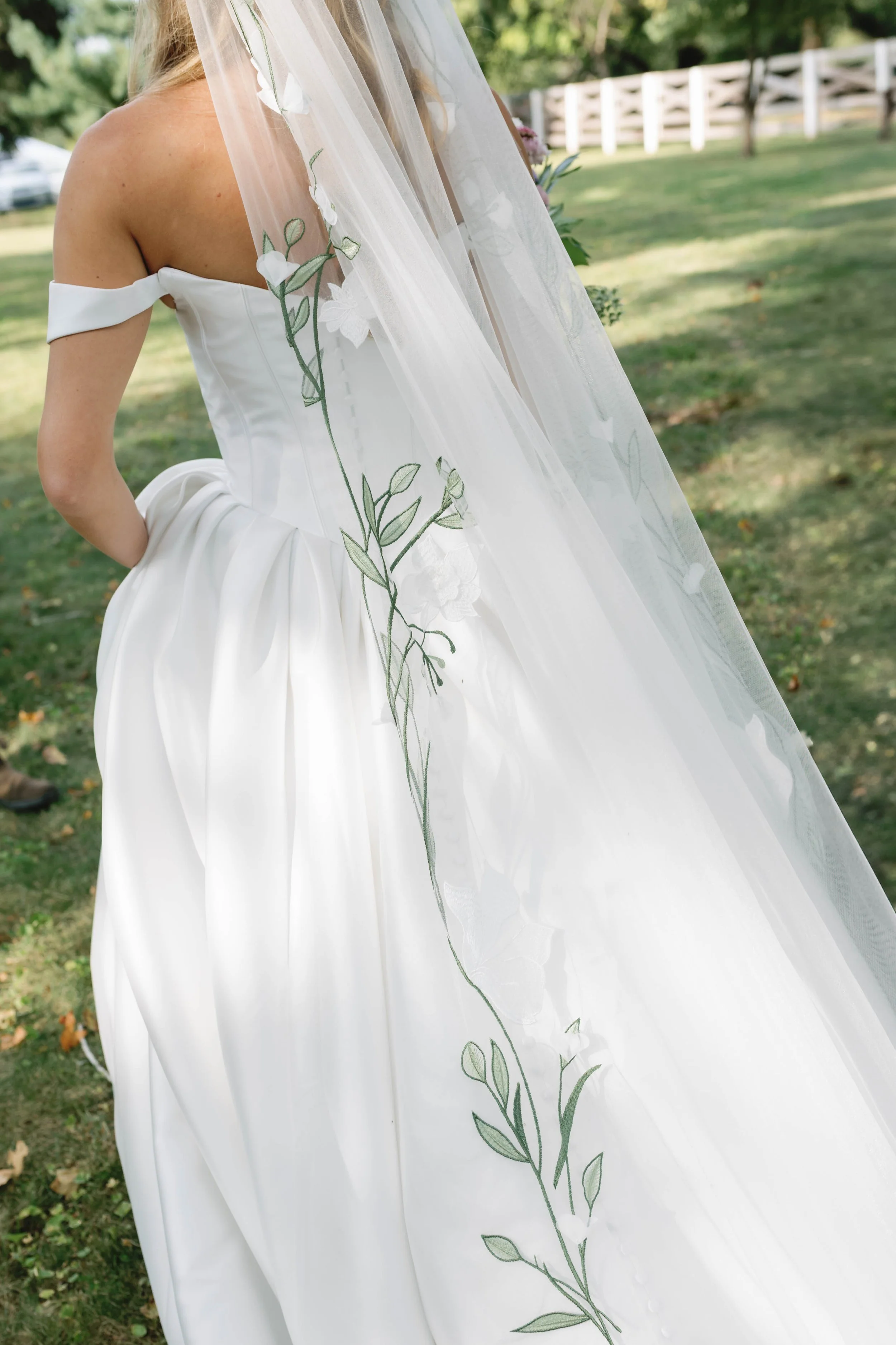 bride with intricate detailed veil with green flowers on it walking in shaker village kentucky wedding