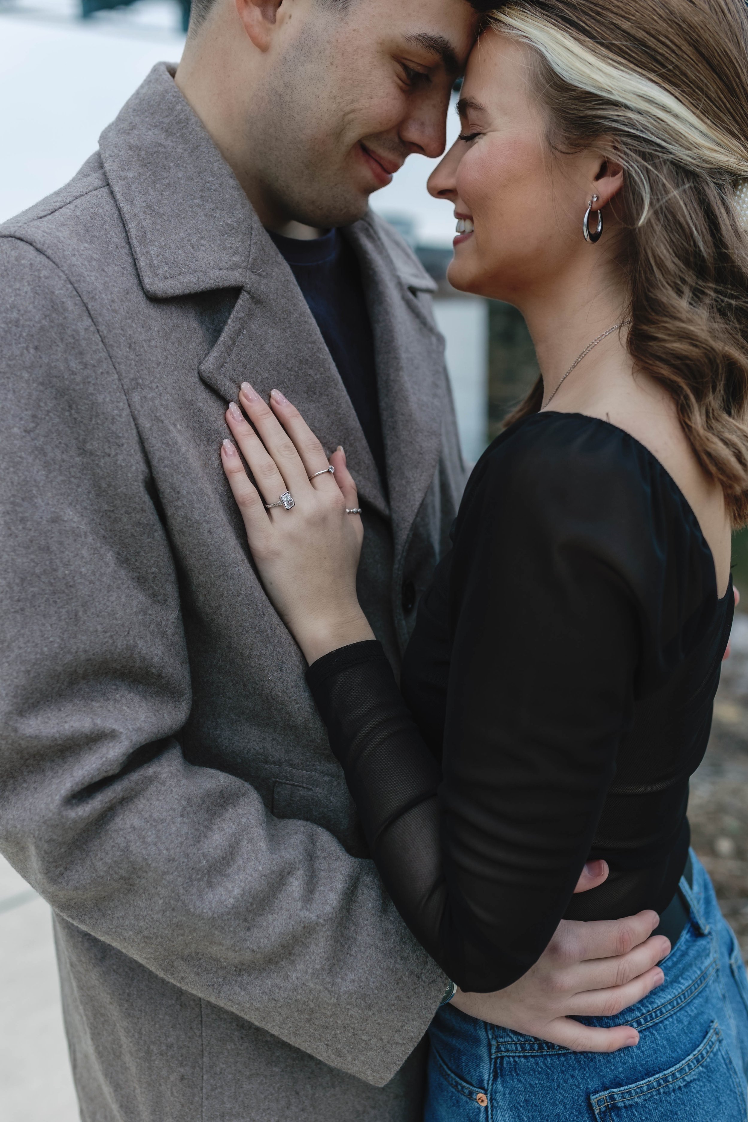 proposal at covington riverwalk with cincinnati skyline in background engagement 