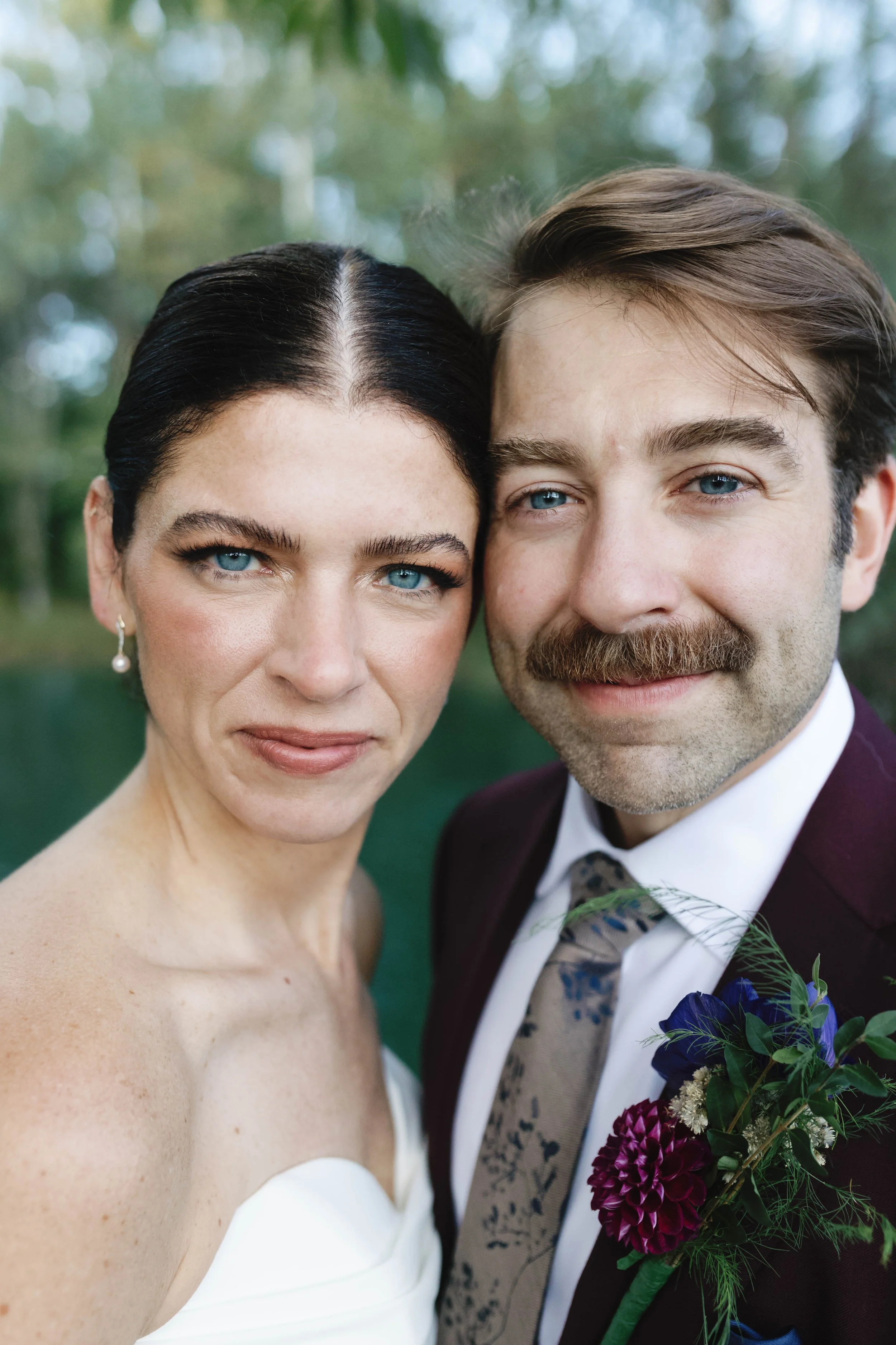 Close-up of a bride and groom smiling outdoors, with trees and greenery in the background. elegant kentucky garden wedding 