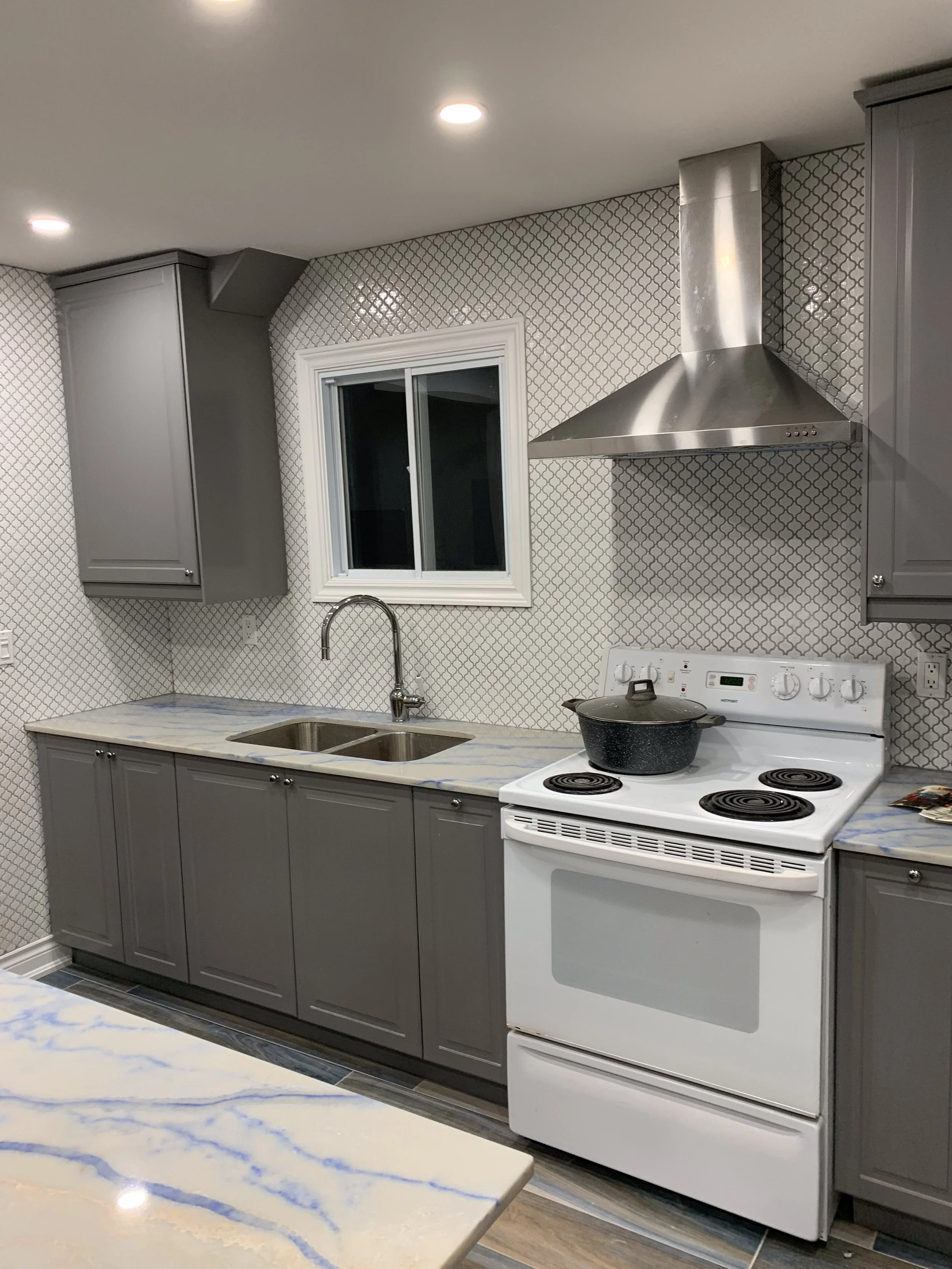 modern renovated kitchen with white and wood accents