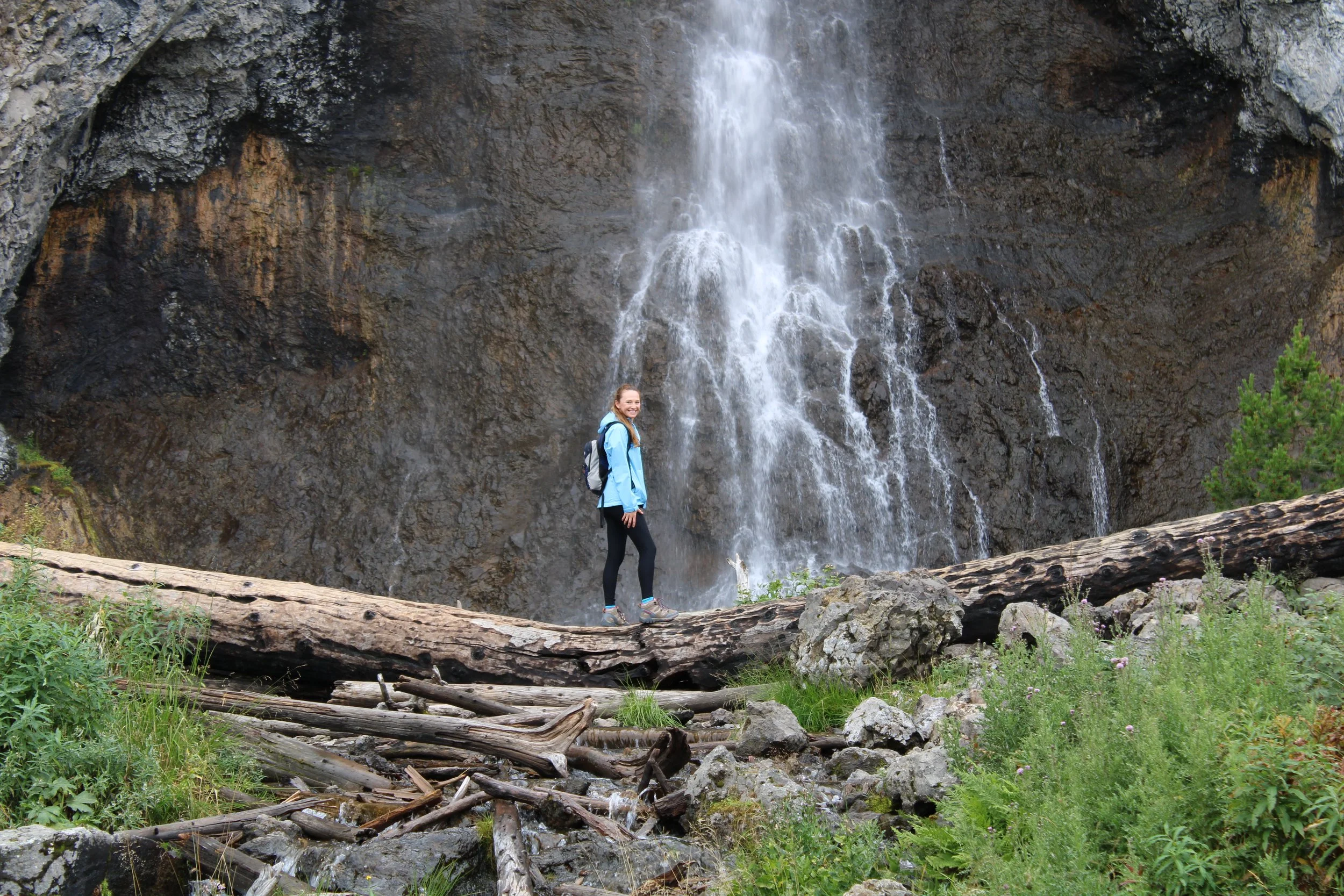 Dr. Kat Thigpen hiking near a waterfall