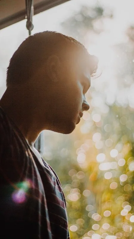 A teen looking out a window