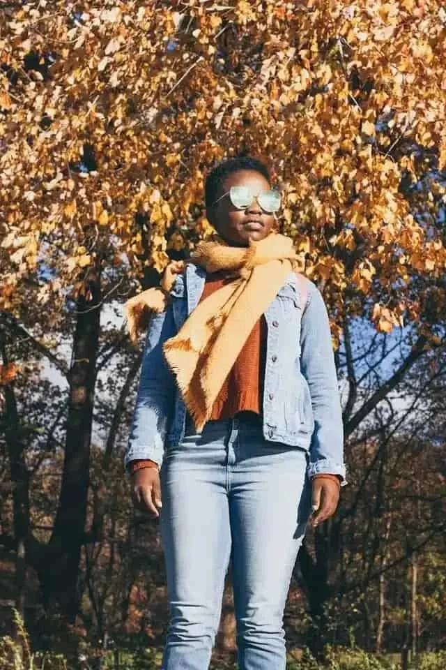 a black woman in sunglasses and a scarf on
