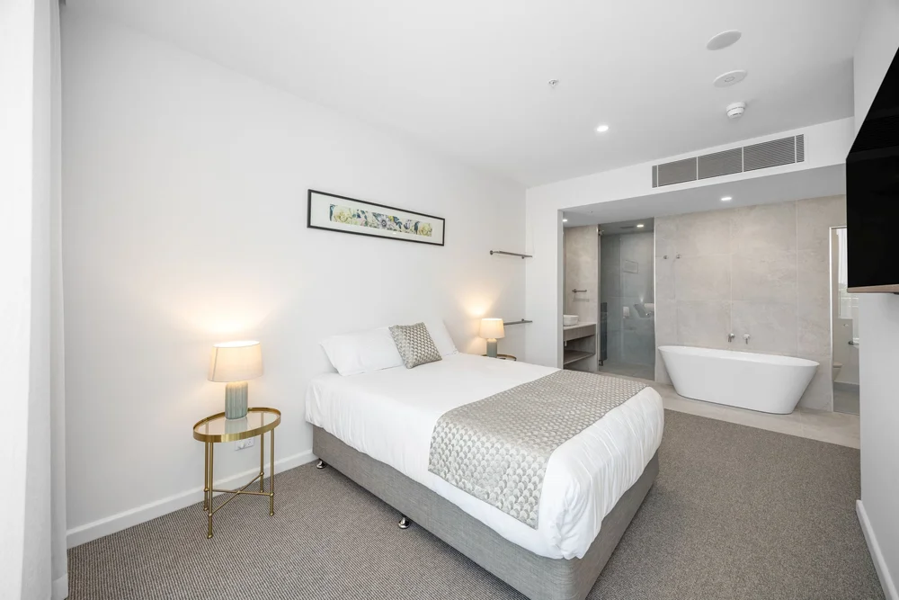 Guest room with freestanding bath at Pelican Waters Golf Resort, Pelican Waters Golf Resort