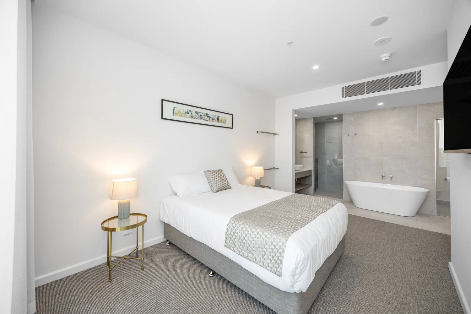 Guest room with freestanding bath at Pelican Waters Golf Resort