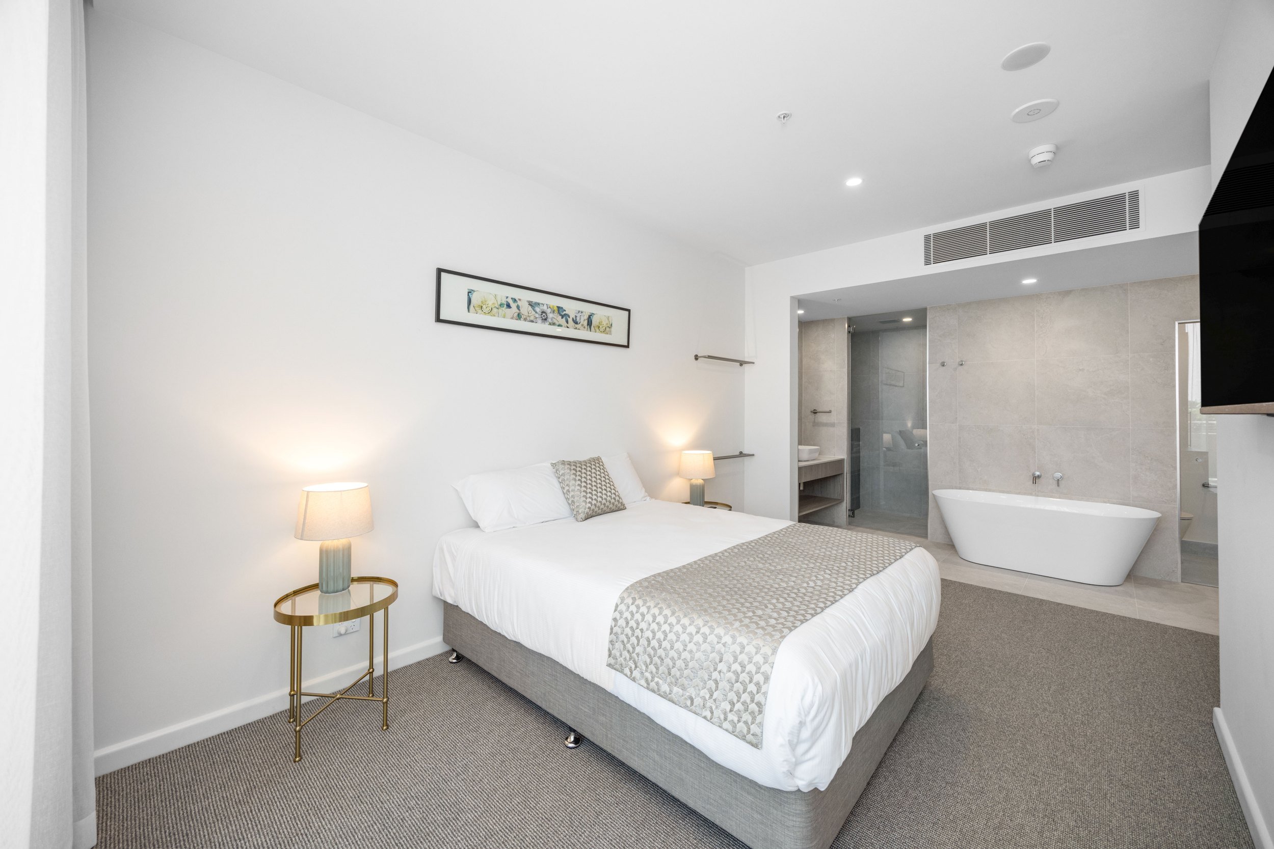 Guest room with freestanding bath at Pelican Waters Golf Resort