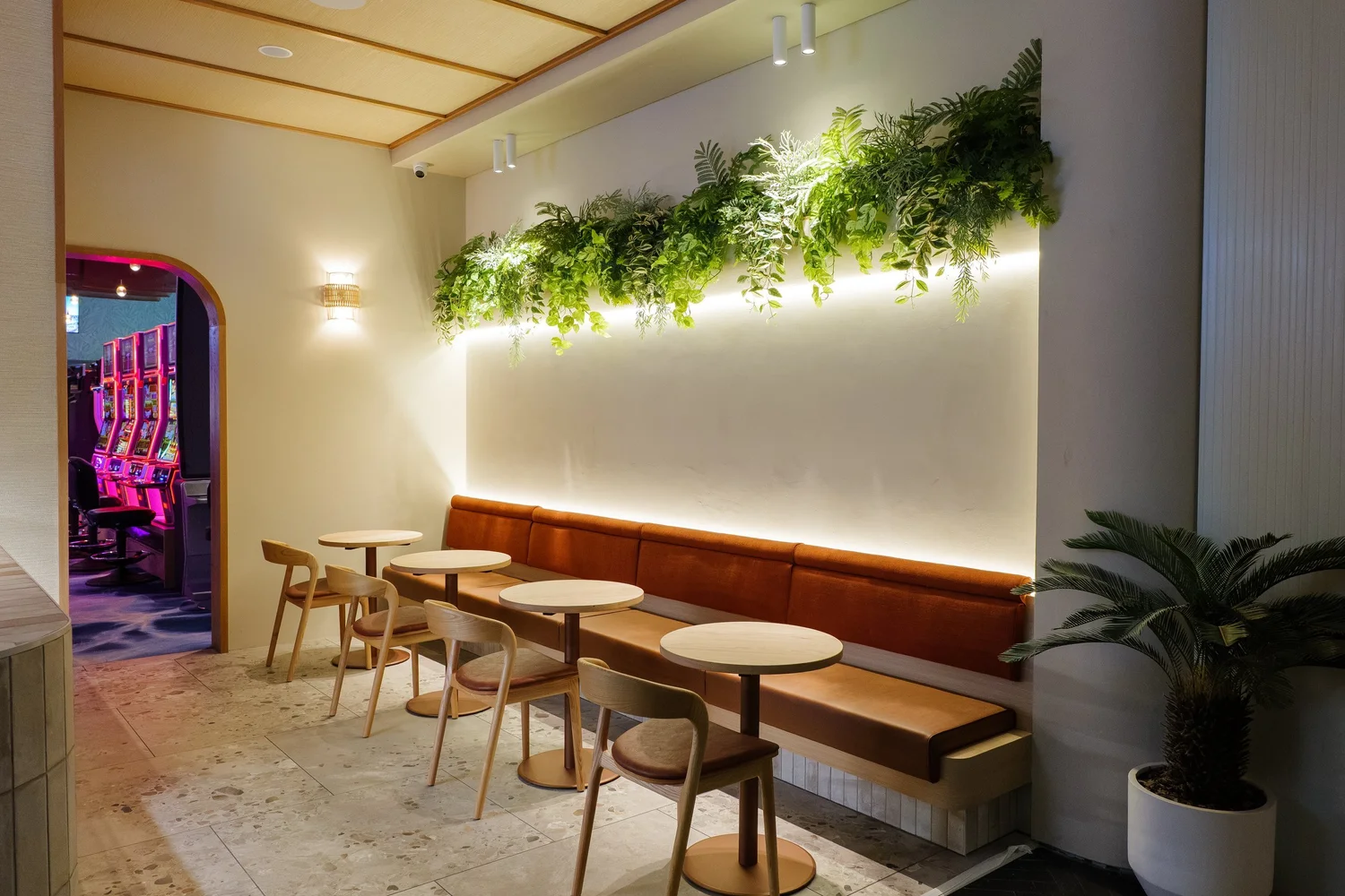 Lounge dining with planted feature wall at The Spinnaker, Yeppoon