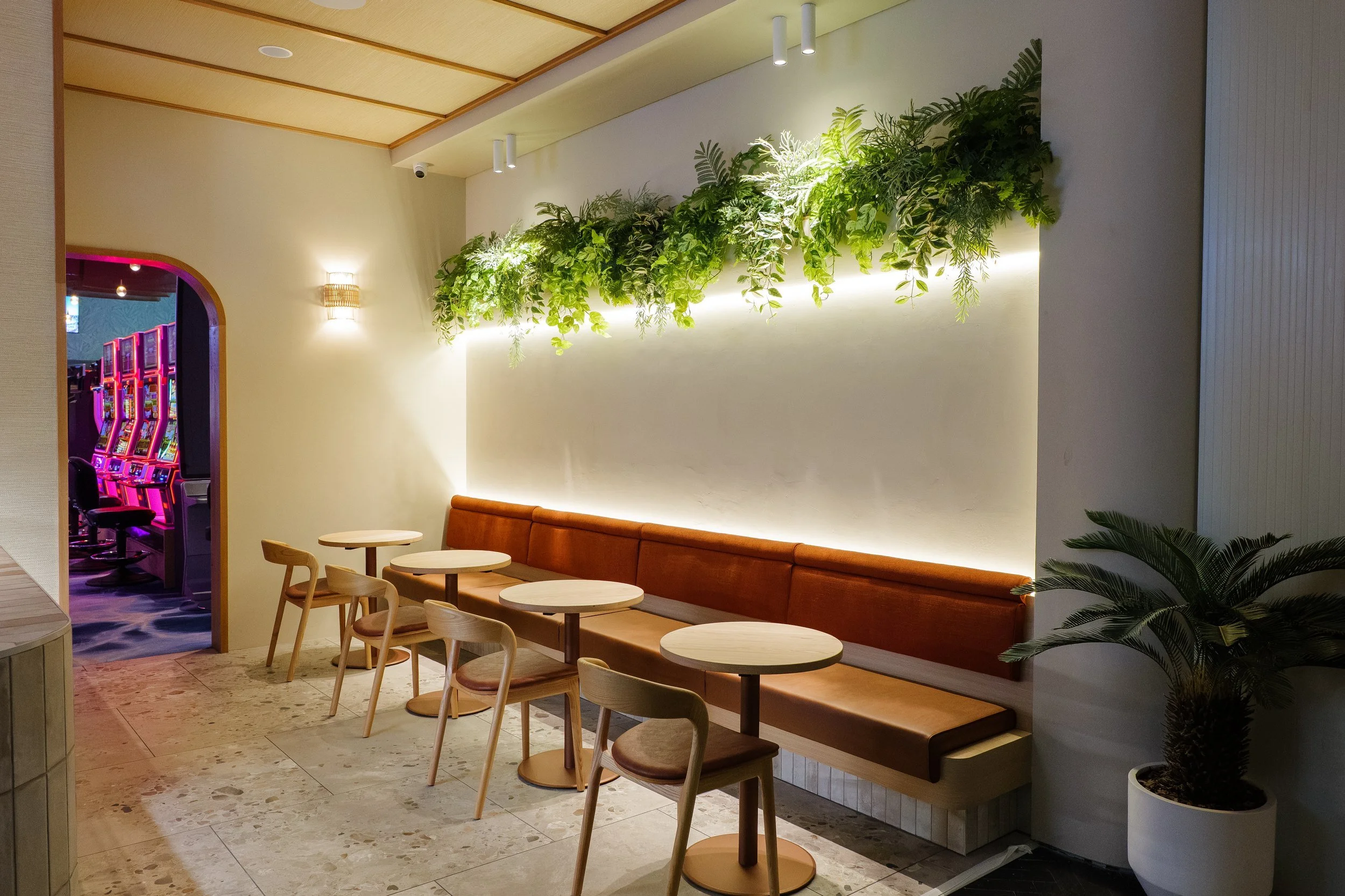 Lounge dining with planted feature wall at The Spinnaker, Yeppoon