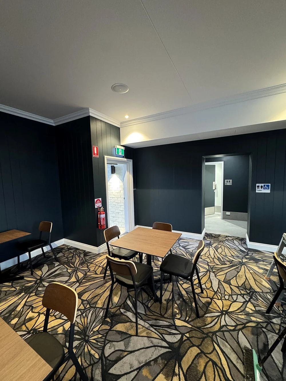 Dining with dark panelled walls, Hotel Kingsley